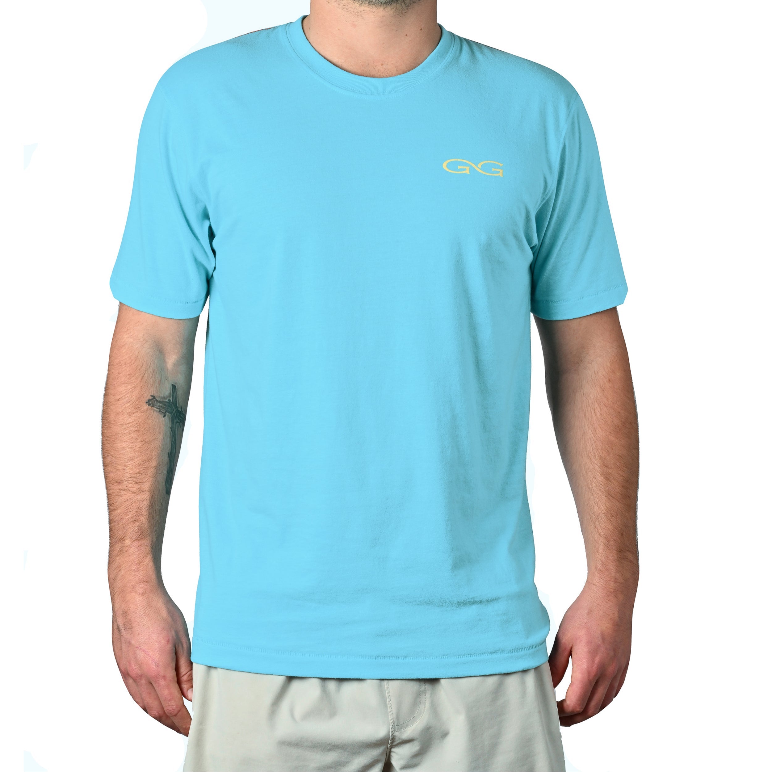 Person wearing a light blue t-shirt with a logo on a white background