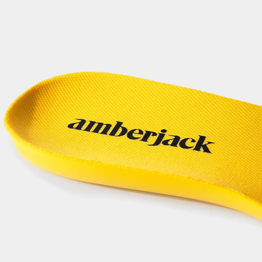 Yellow shoe insole with 'amberjack' branding on a white background