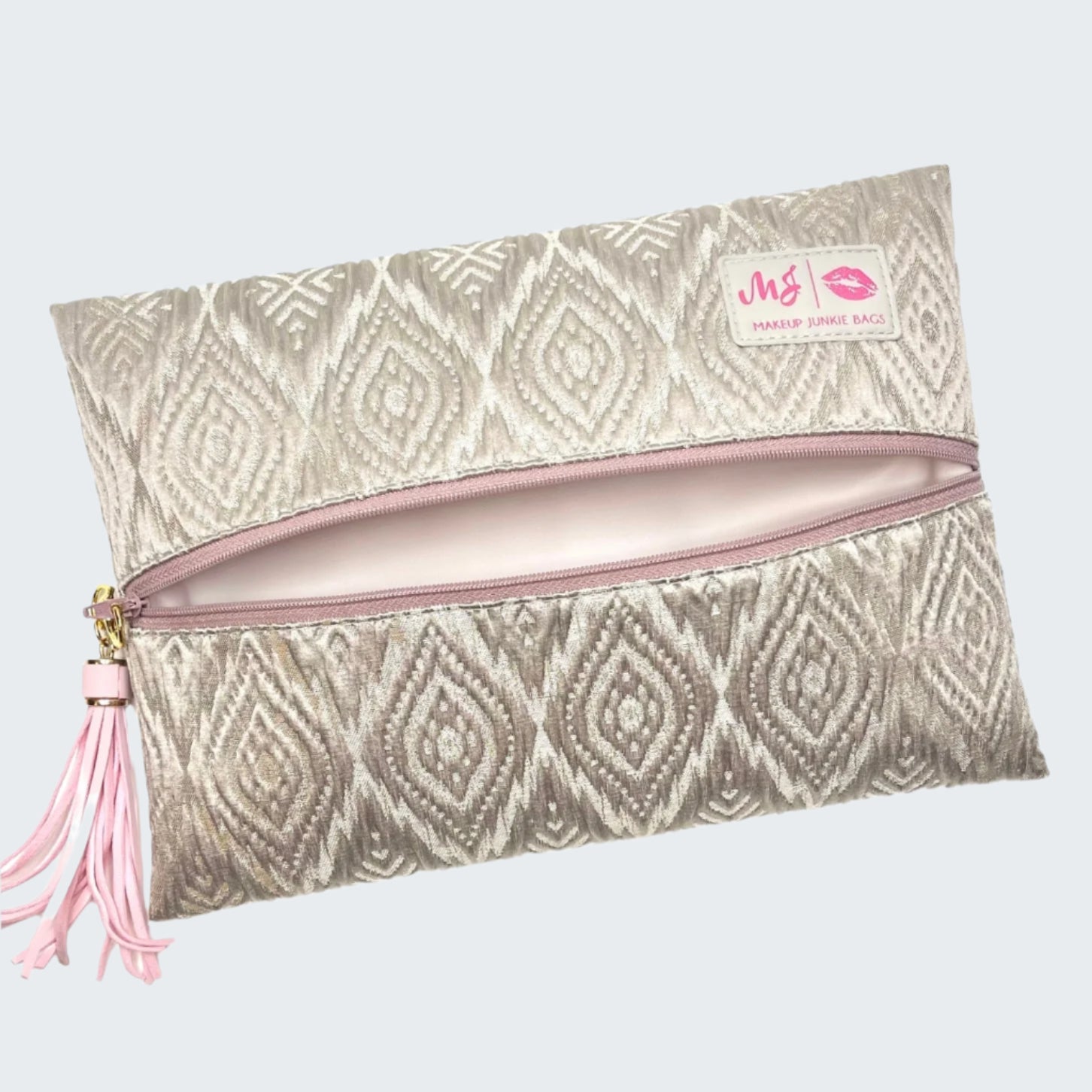 Patterned pouch with pink zipper and tassel on a white background