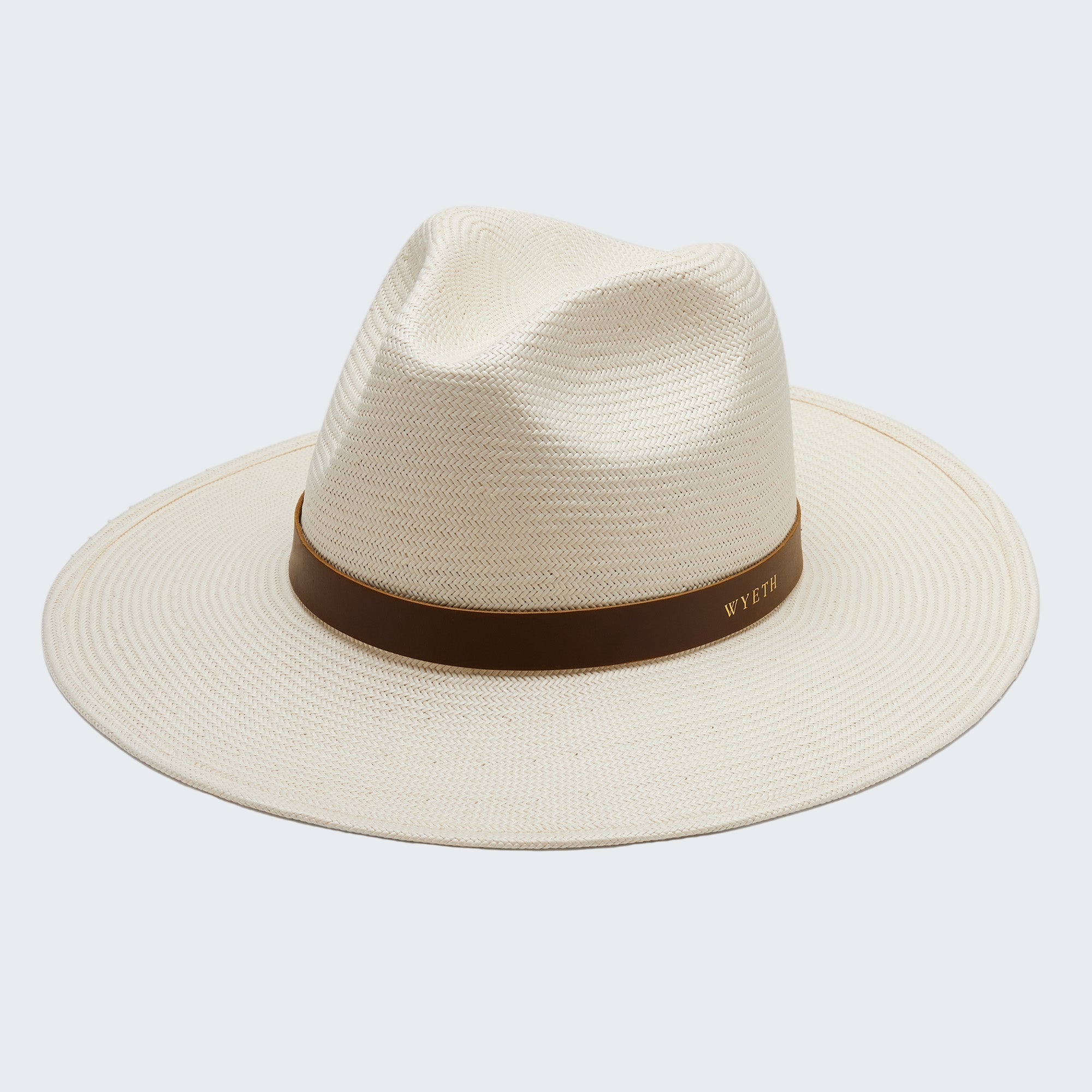 Beige straw hat with a brown band on a white background
