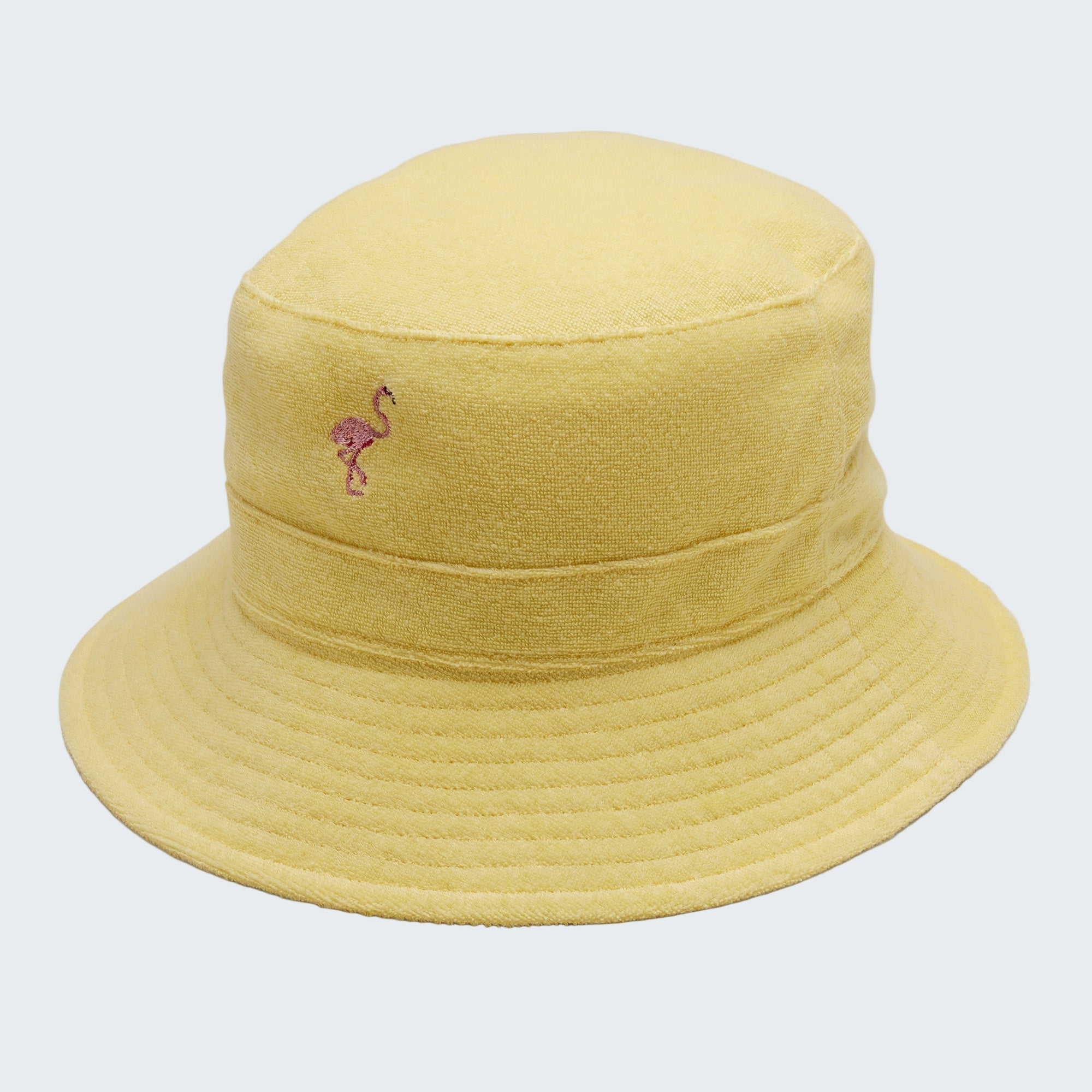 Yellow bucket hat with a flamingo emblem on a light gray background