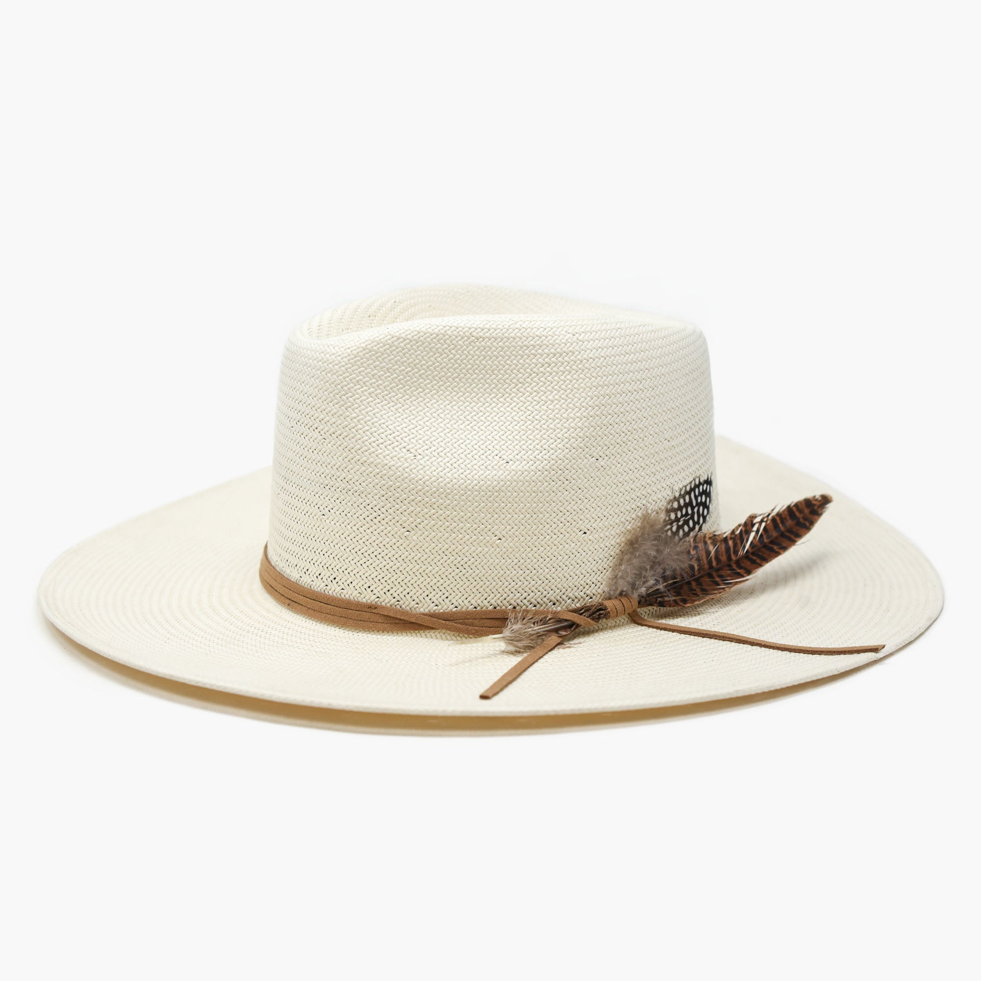 White straw hat with a brown band and feather on a white background