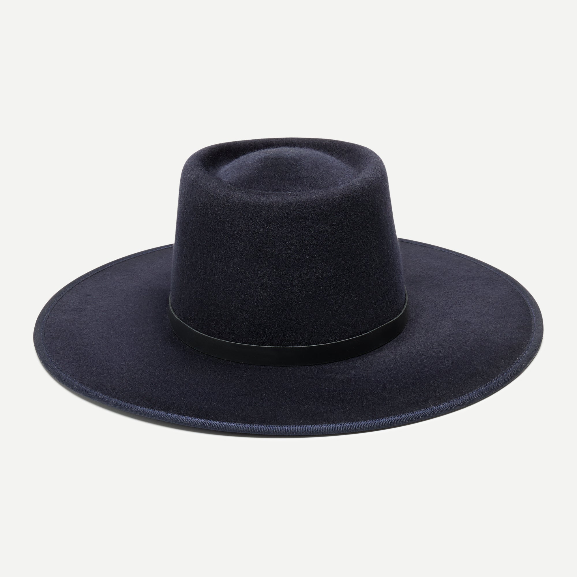 Navy blue fedora hat on a light gray background