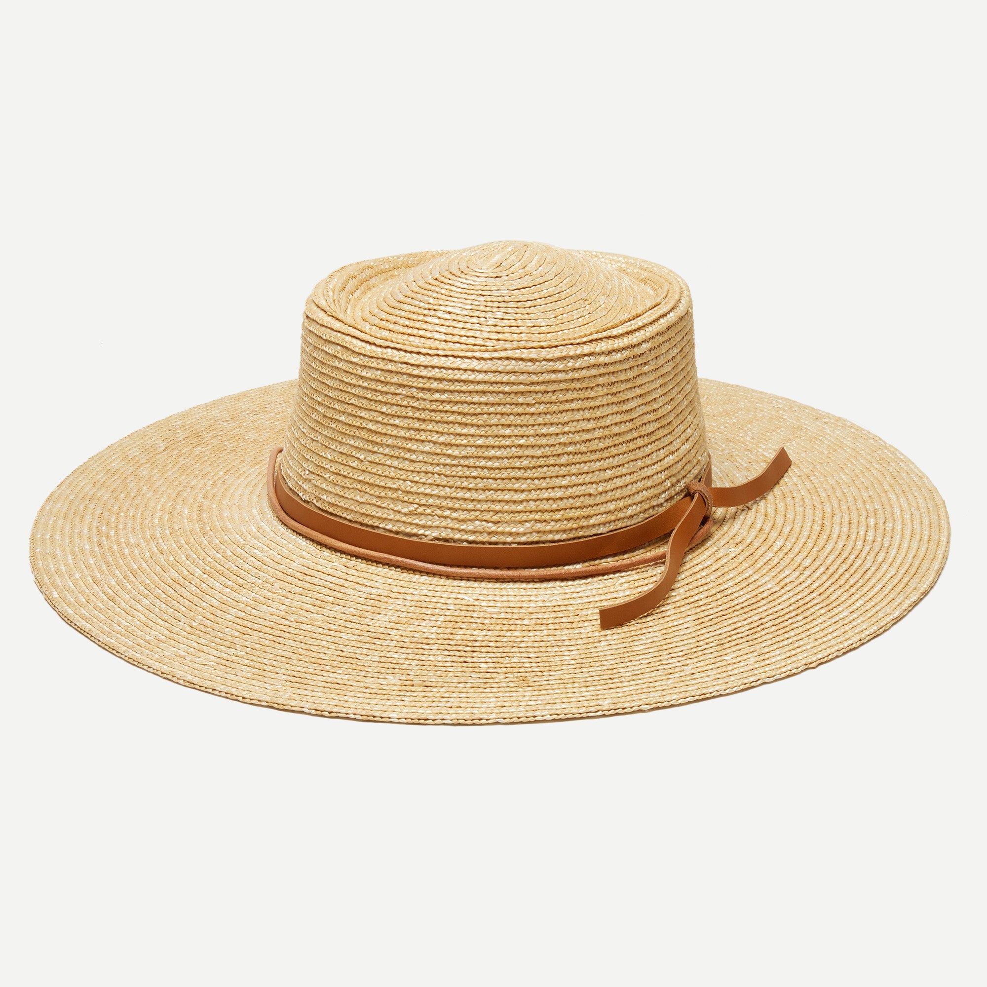 Beige straw hat with a brown band on a white background
