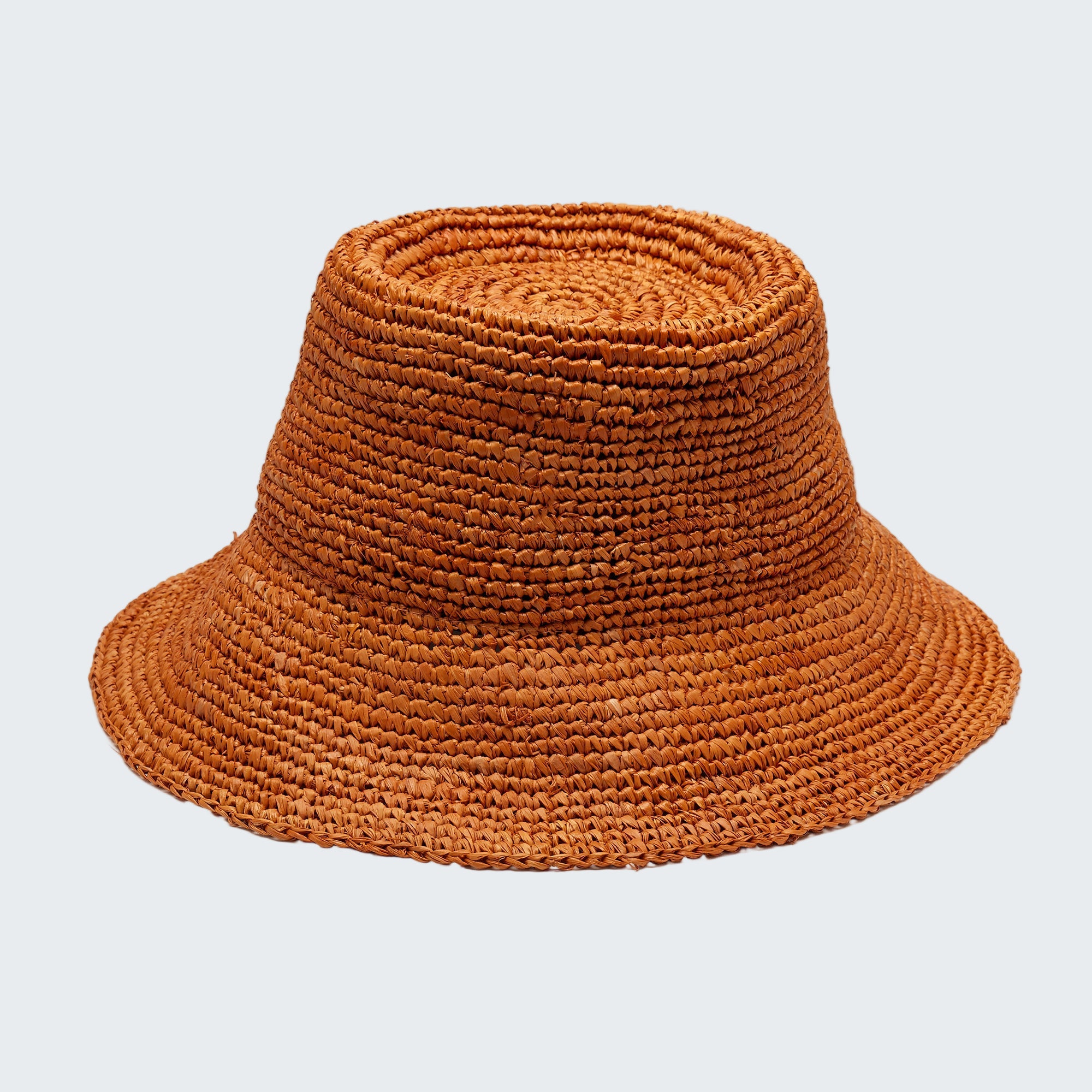 Brown woven bucket hat on a white background