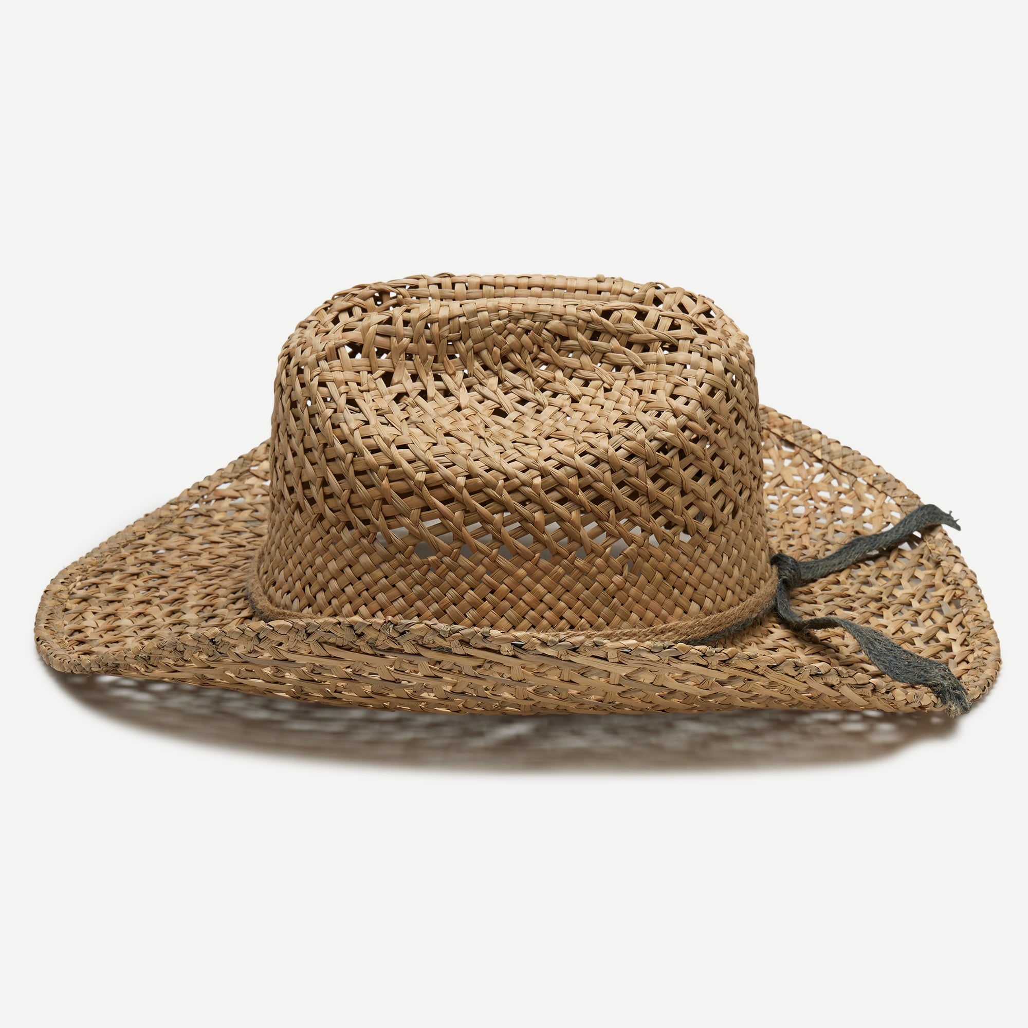 Woven straw hat with a band on a white background