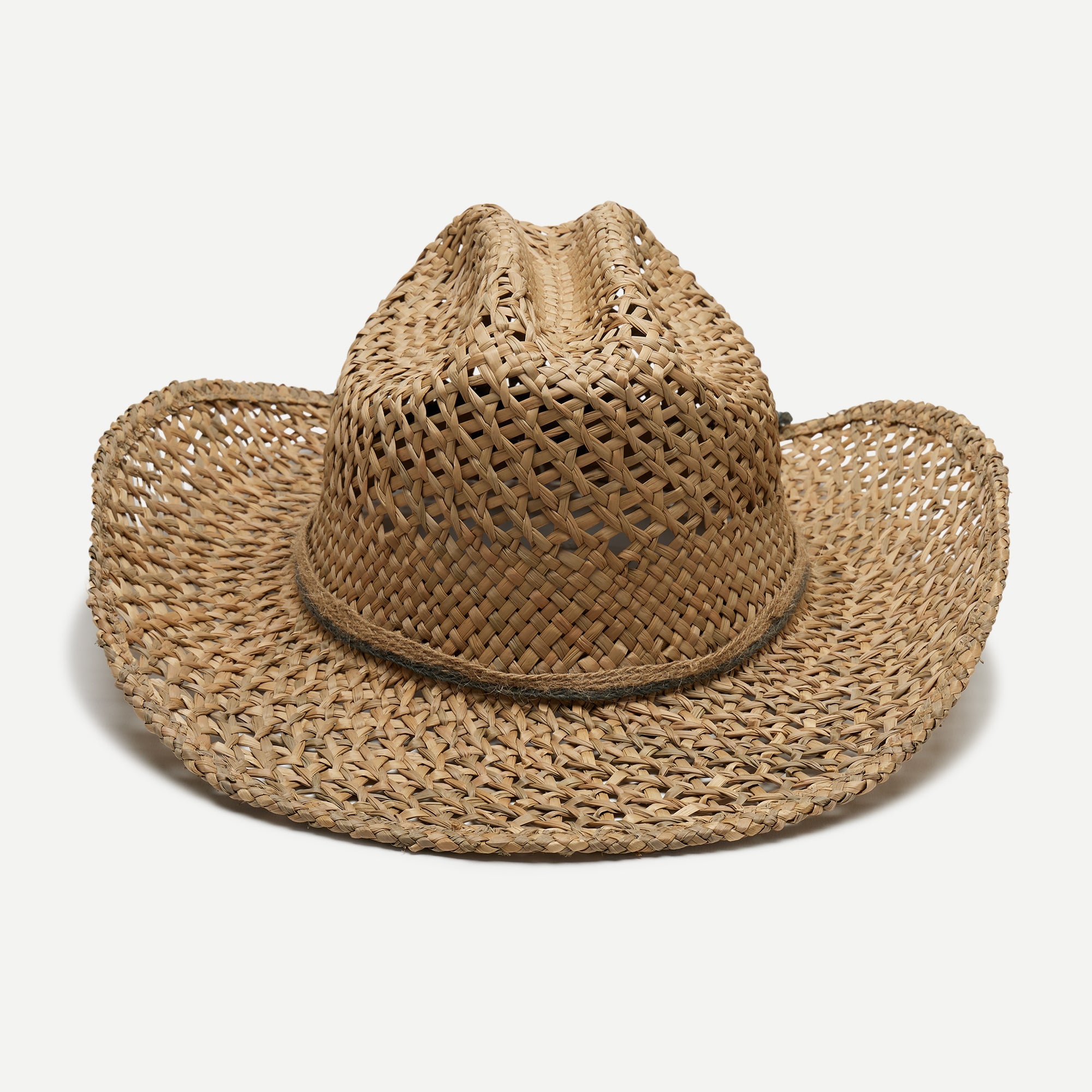 Woven straw cowboy hat on a light gray background