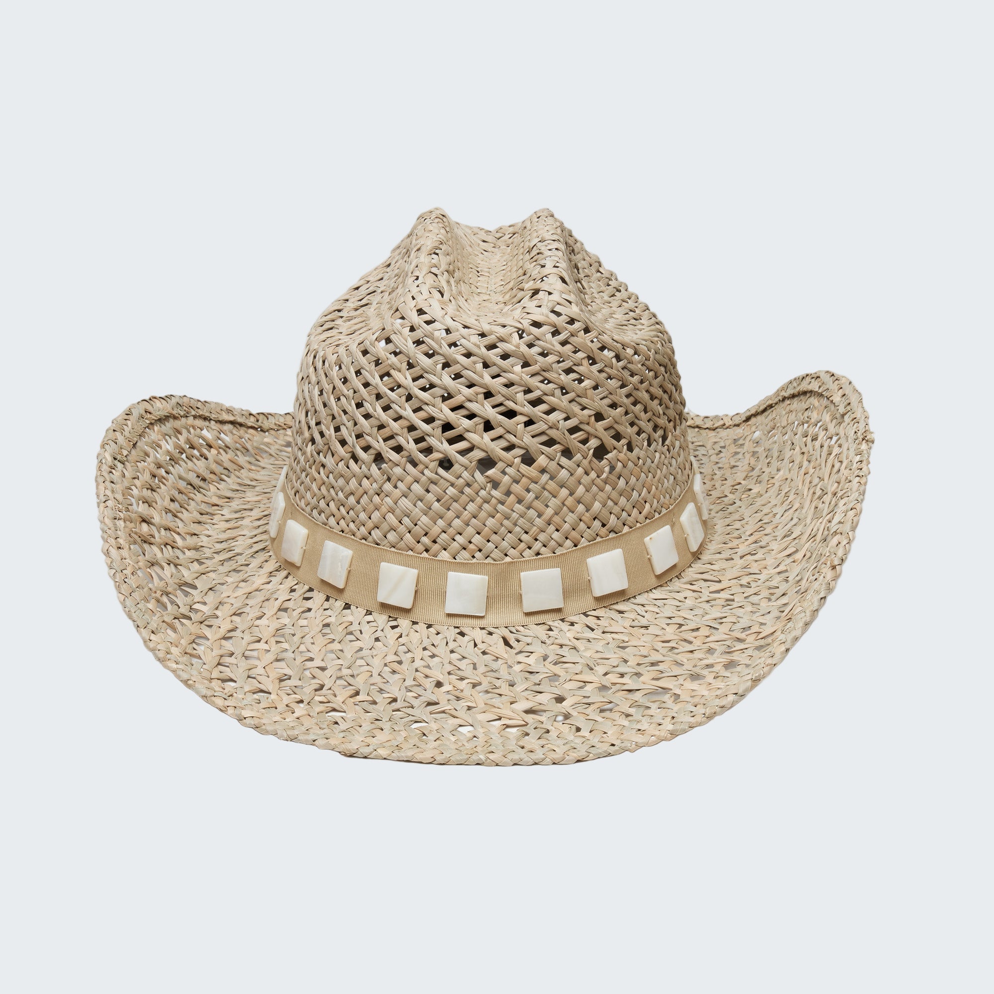 Beige straw cowboy hat with a band on a white background