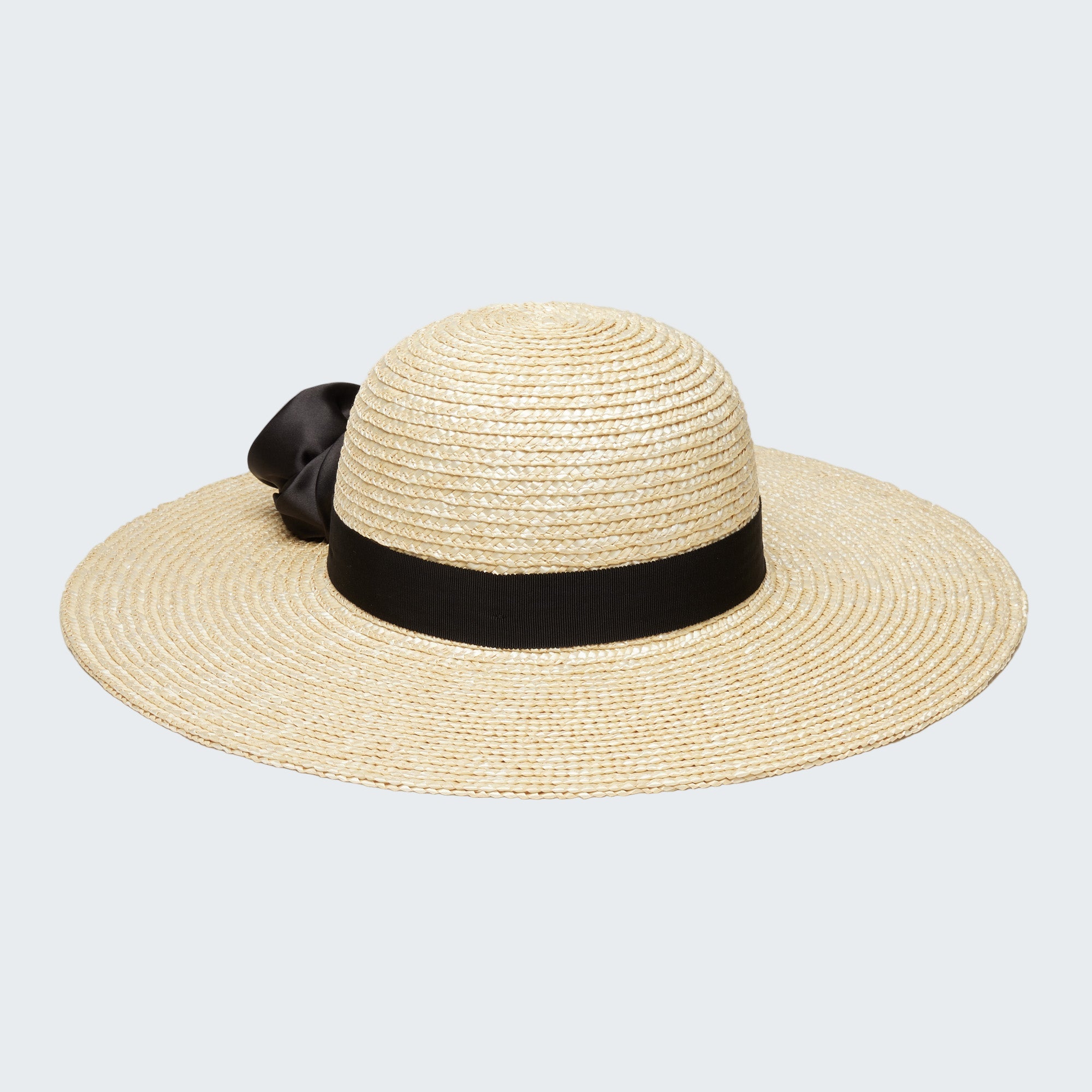 Beige straw hat with a black ribbon on a white background