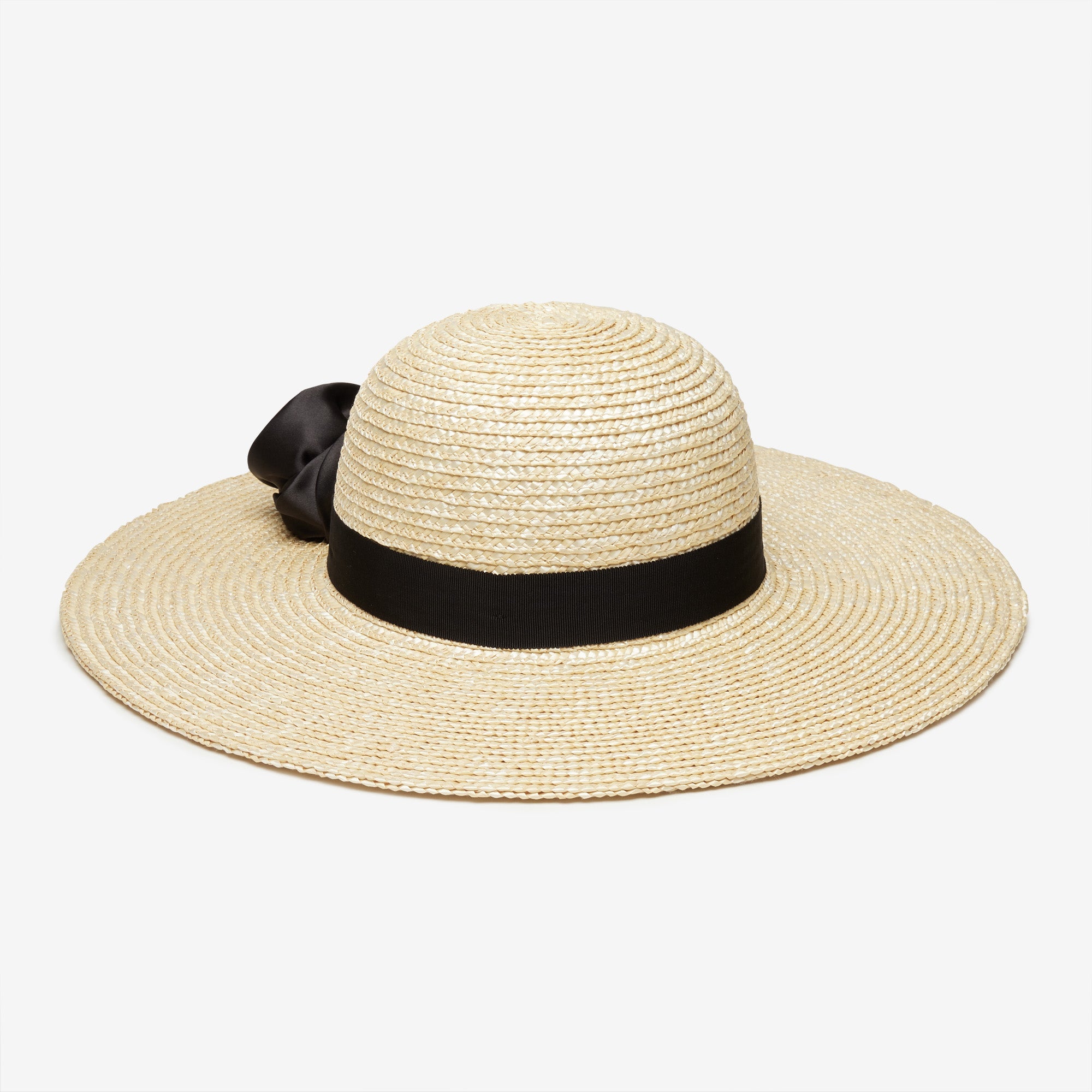 Beige straw hat with a black ribbon on a white background
