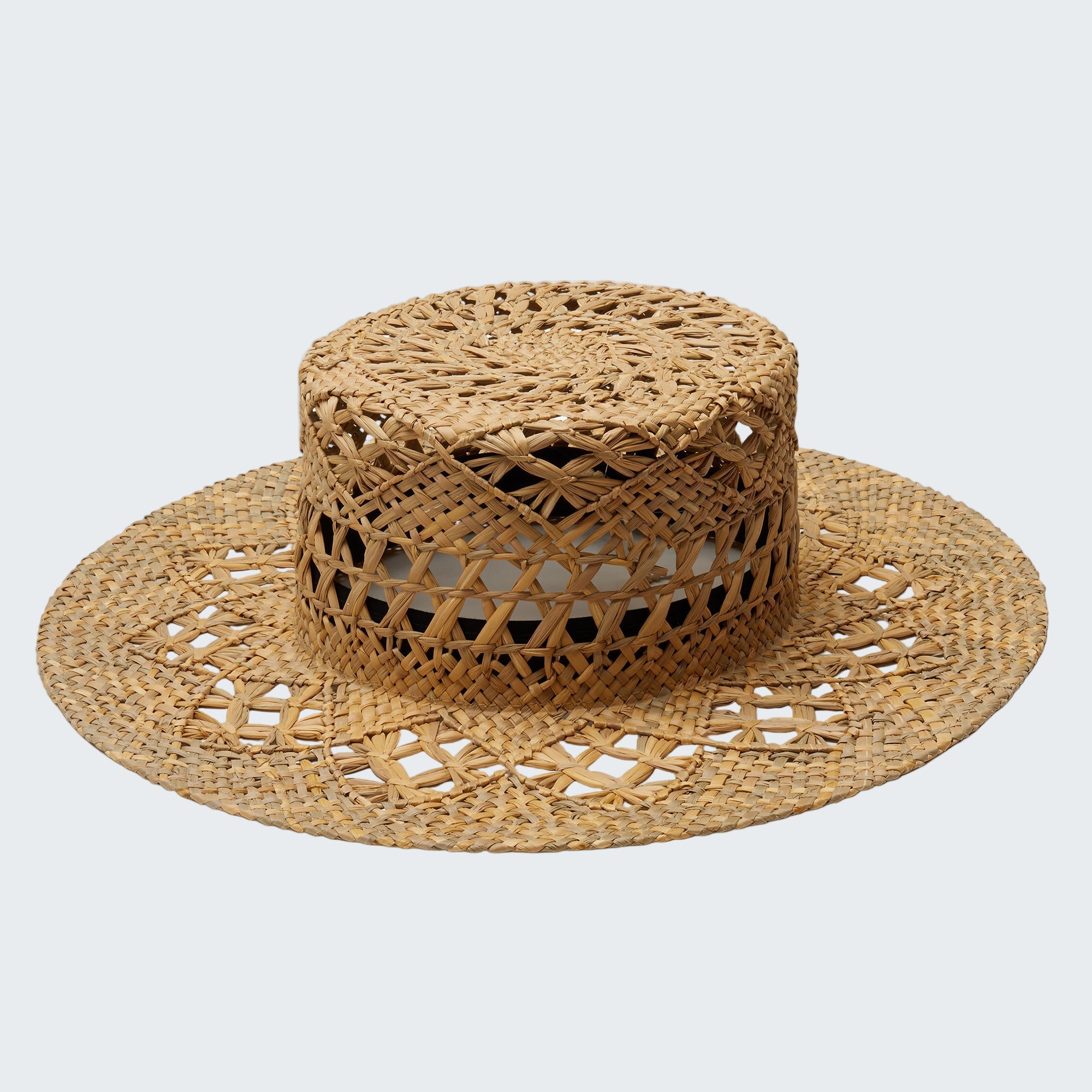 Woven straw hat with wide brim on a white background