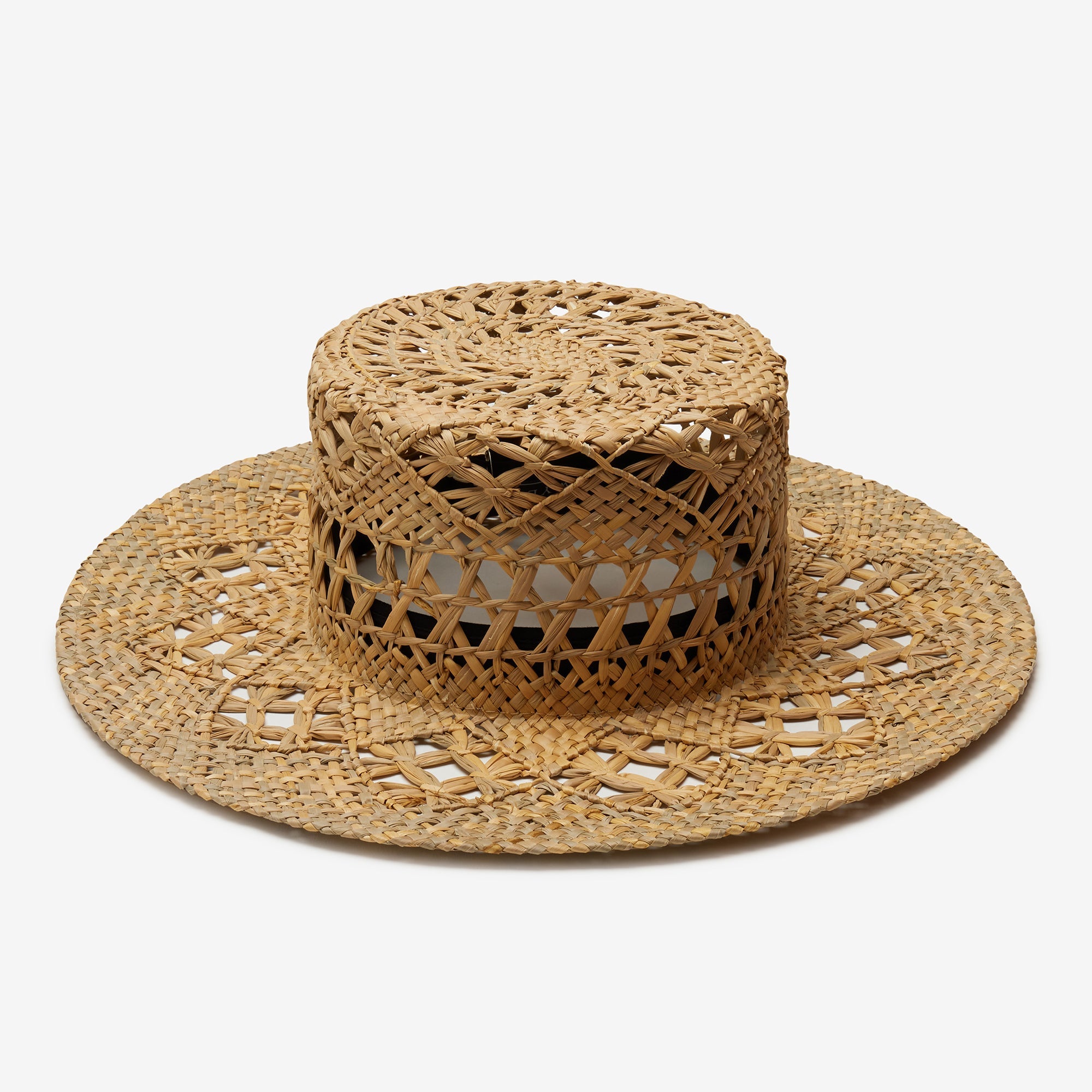 Woven straw hat with a wide brim on a white background