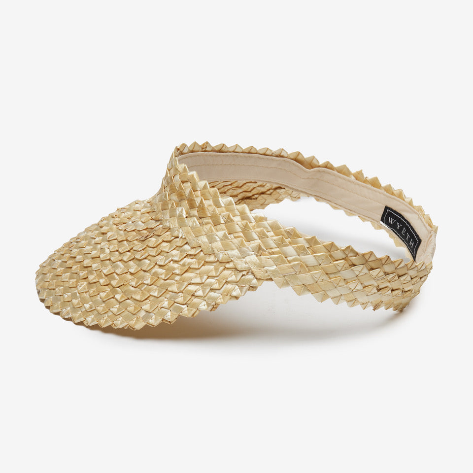 Beige woven visor hat on a white background