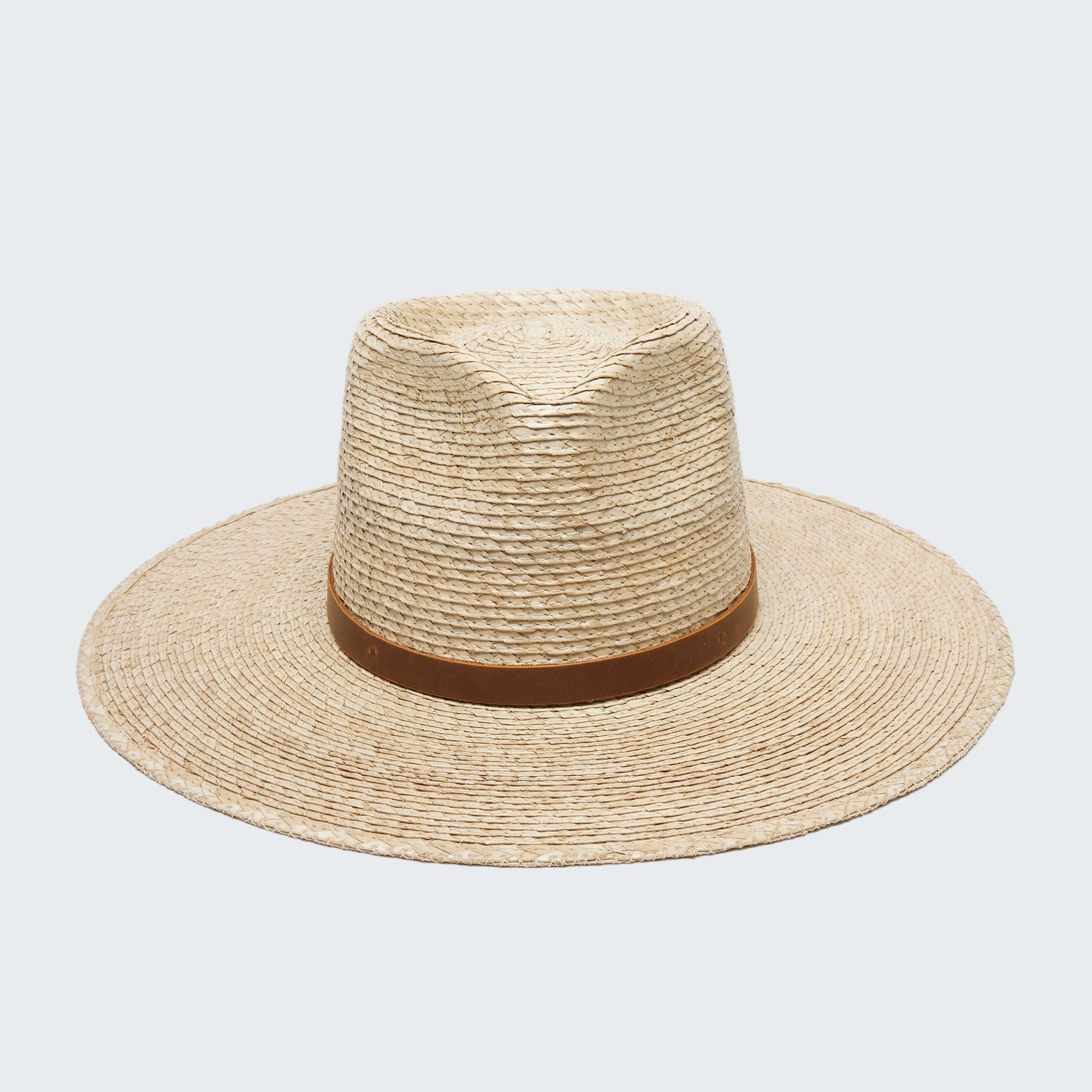 Beige straw hat with a brown band on a white background
