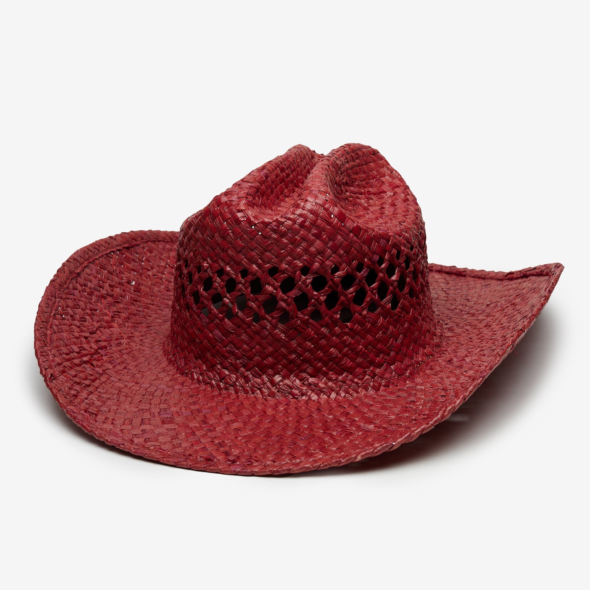 Red straw cowboy hat with a textured design on a white background