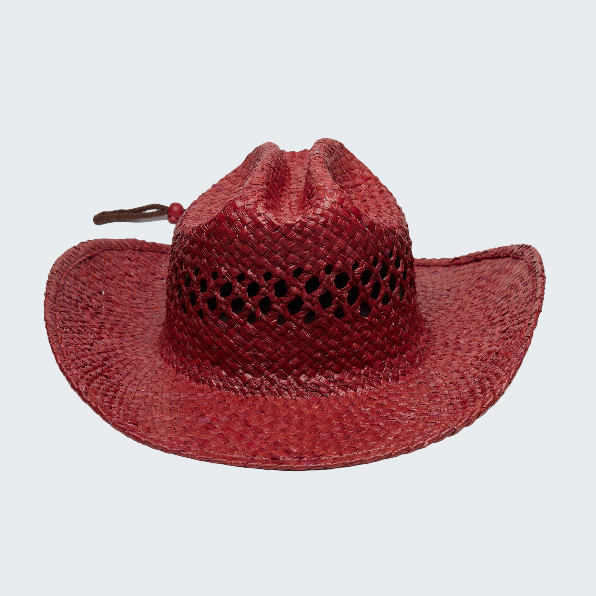 Red straw hat with a wide brim on a white background
