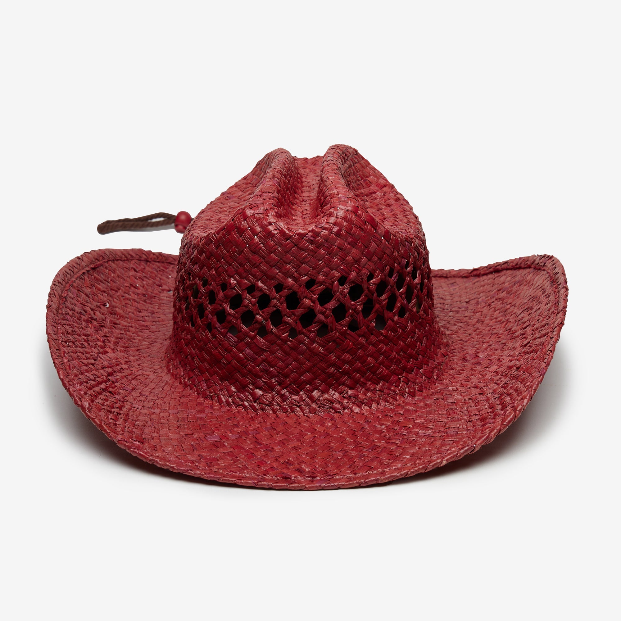 Red straw hat with a wide brim on a white background