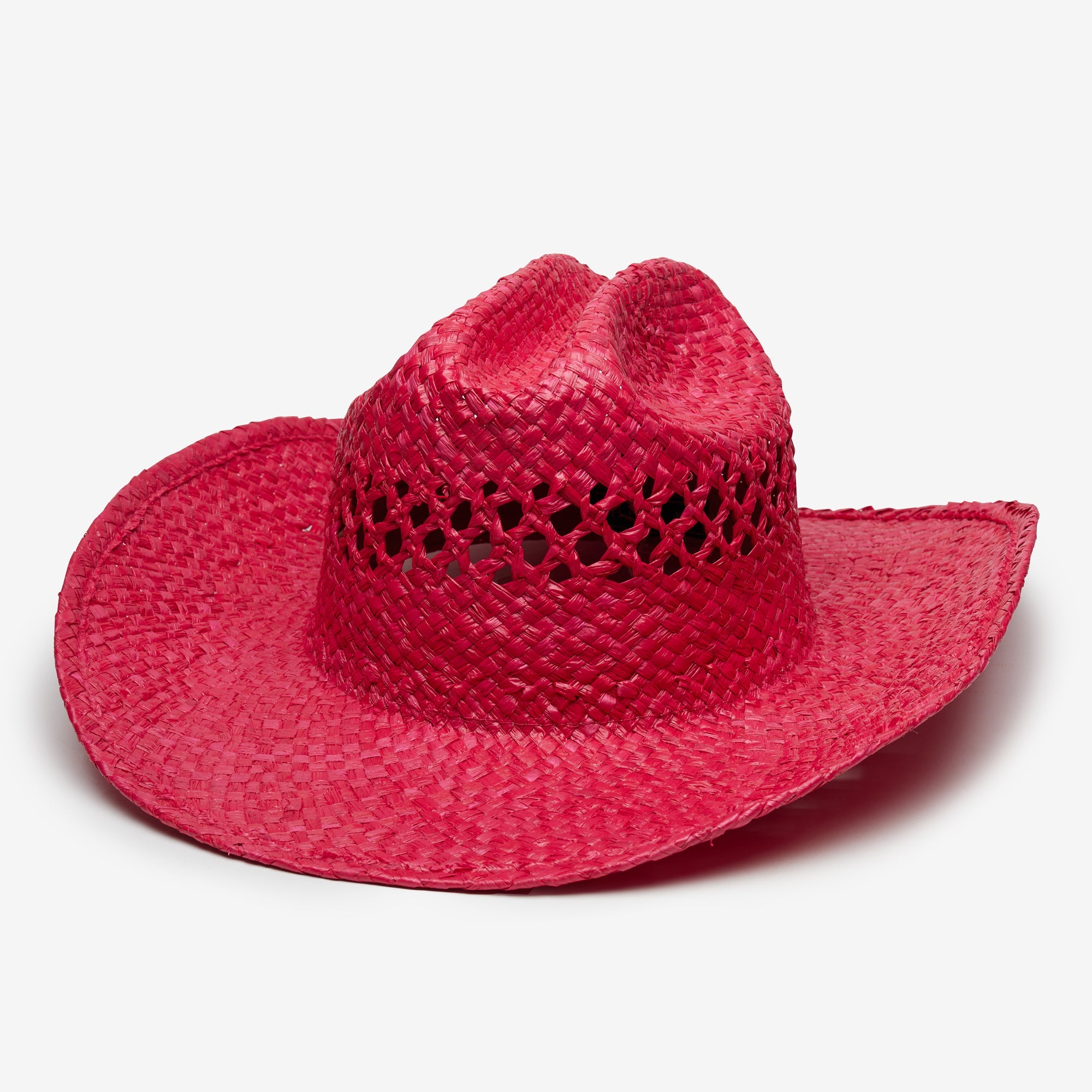 Red straw cowboy hat on a light gray background