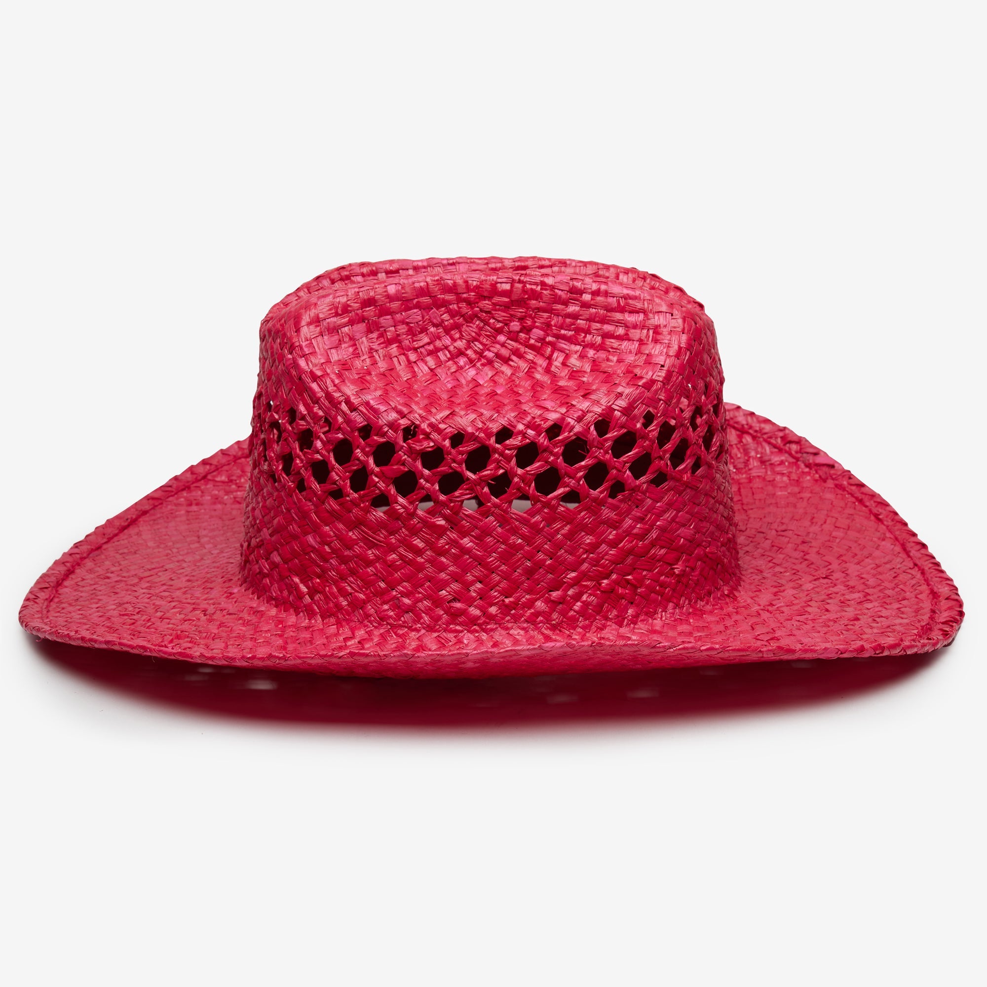 Pink straw hat with a decorative band on a white background