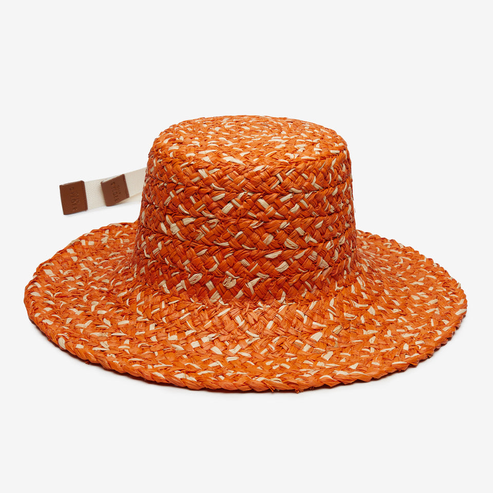 Orange woven sun hat with a brown and white band on a white background