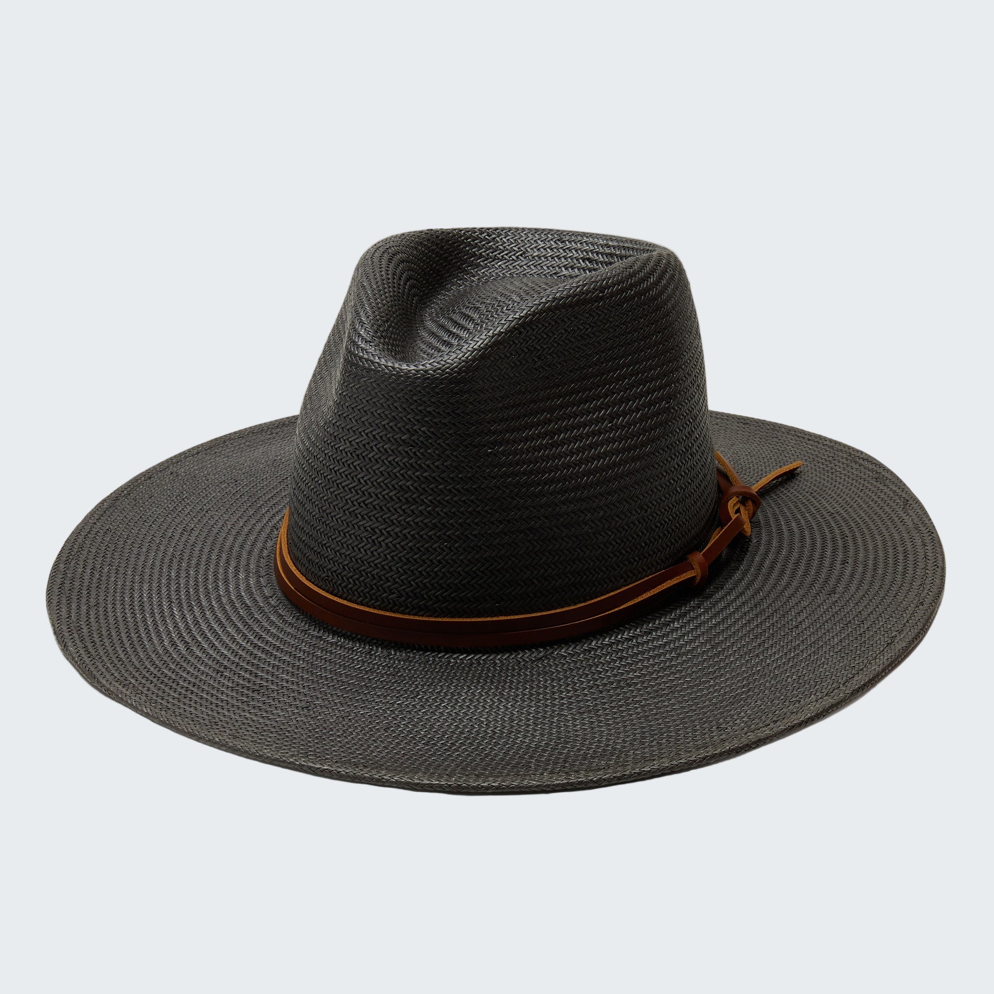 Black straw hat with a brown band on a white background