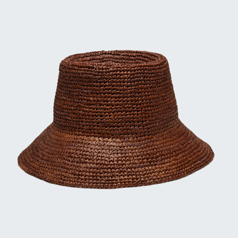 Brown woven bucket hat on a white background
