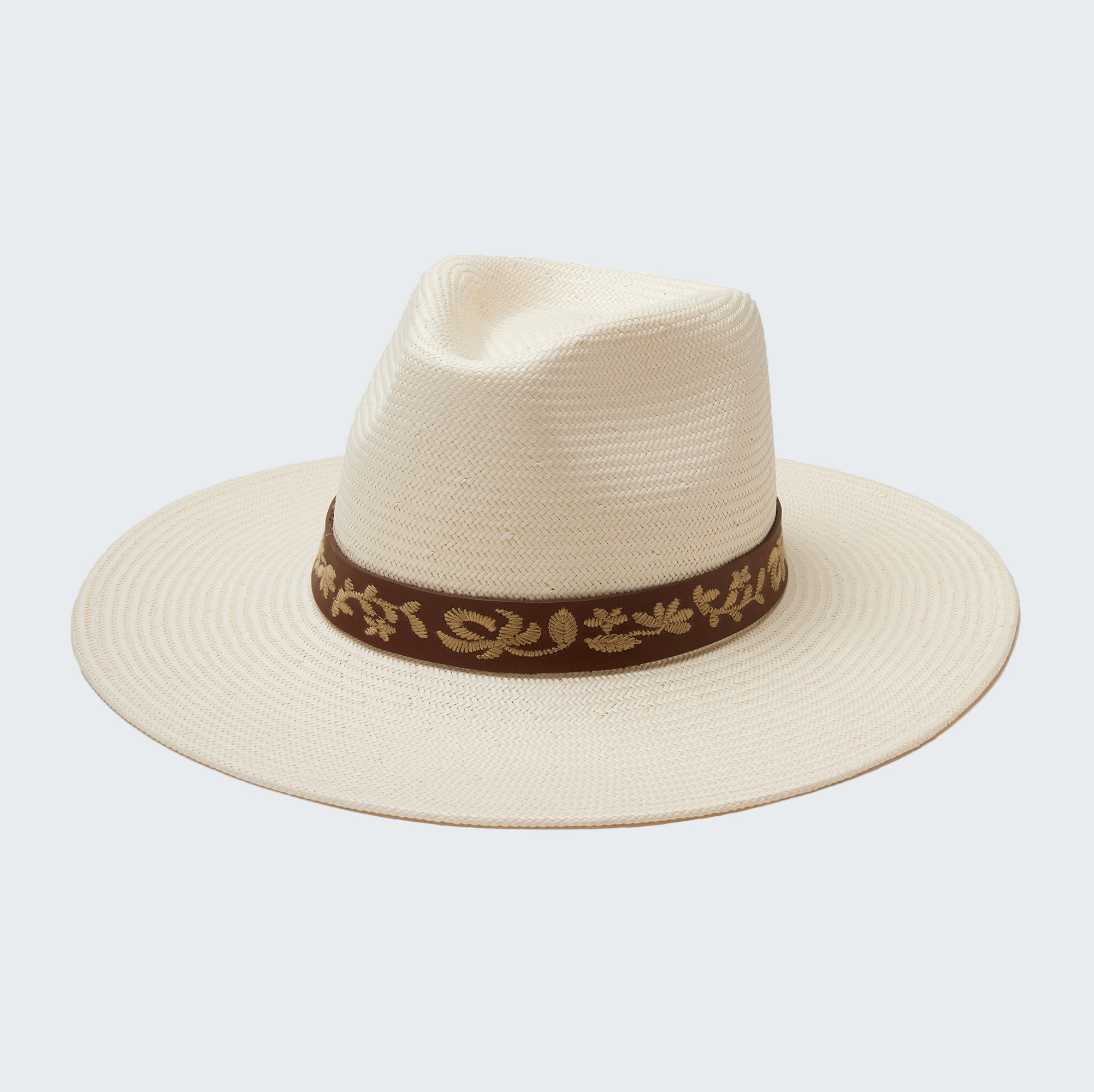 Beige straw hat with a brown band featuring gold embroidery on a white background