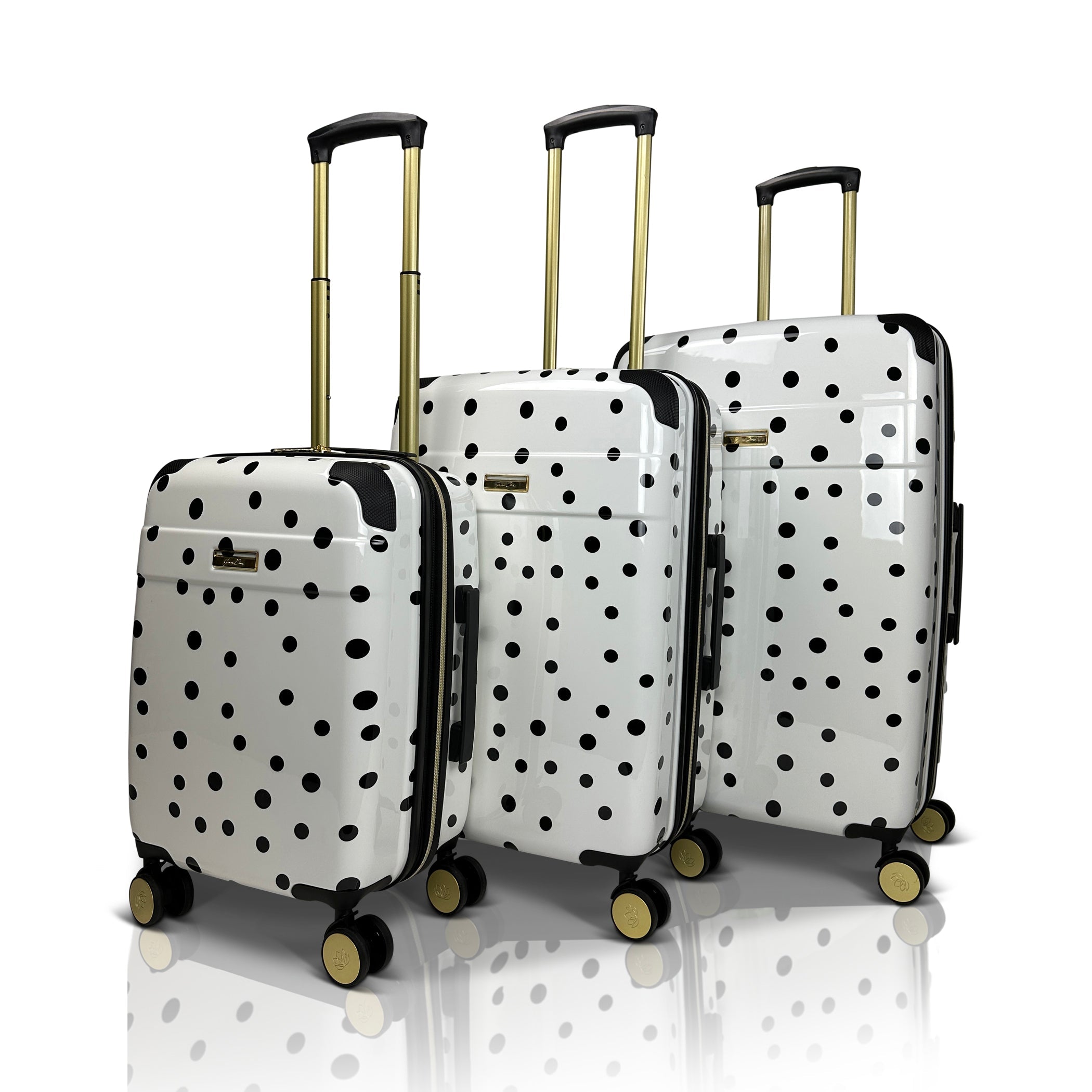 Set of three polka dot suitcases on a white background