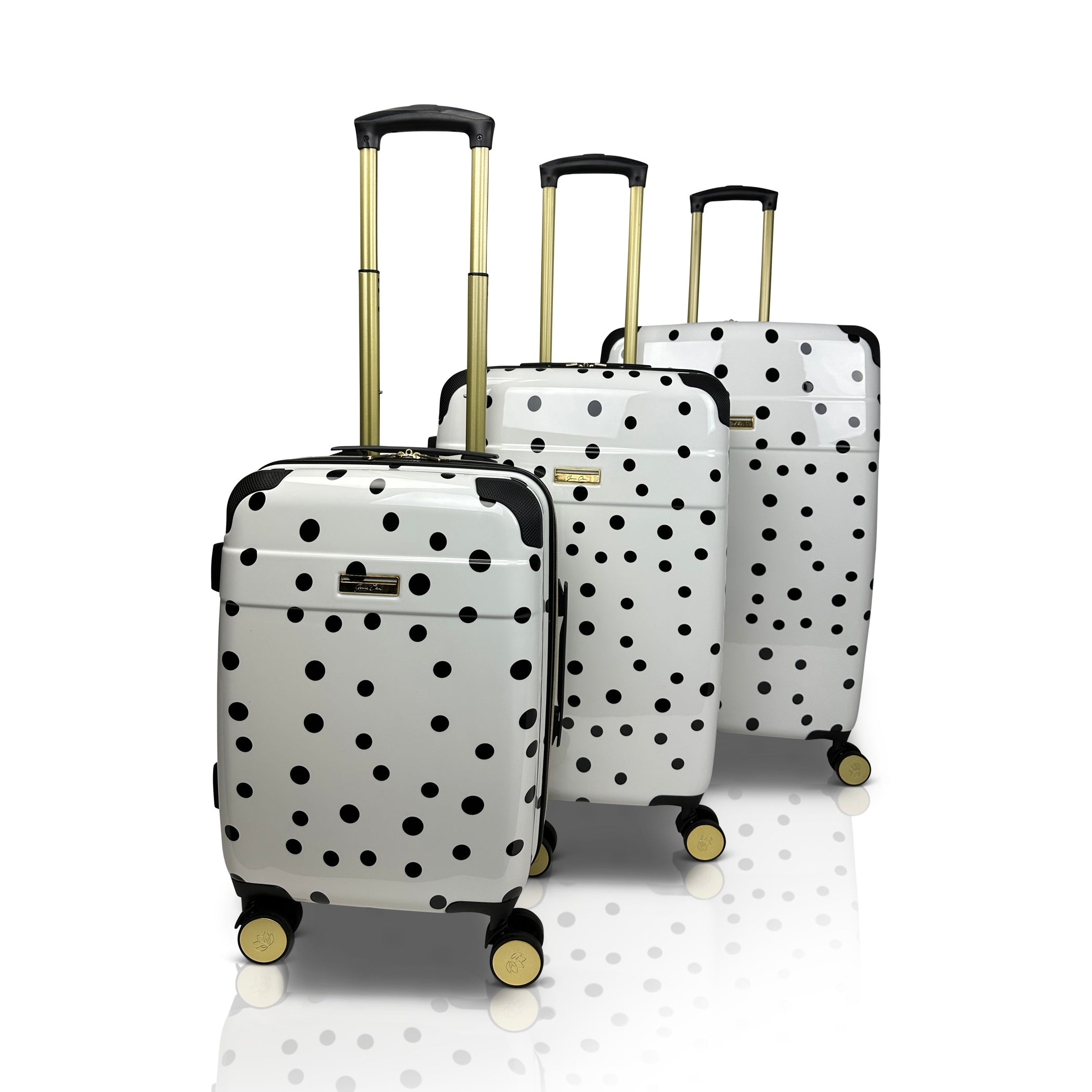 Set of three polka dot suitcases on a white background