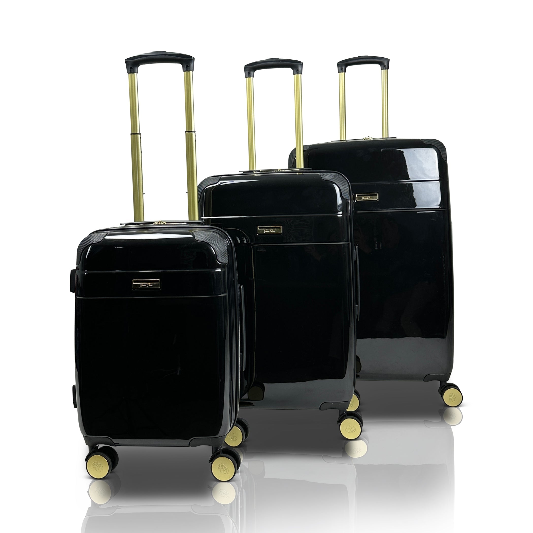 Set of three black suitcases with gold handles on a white background