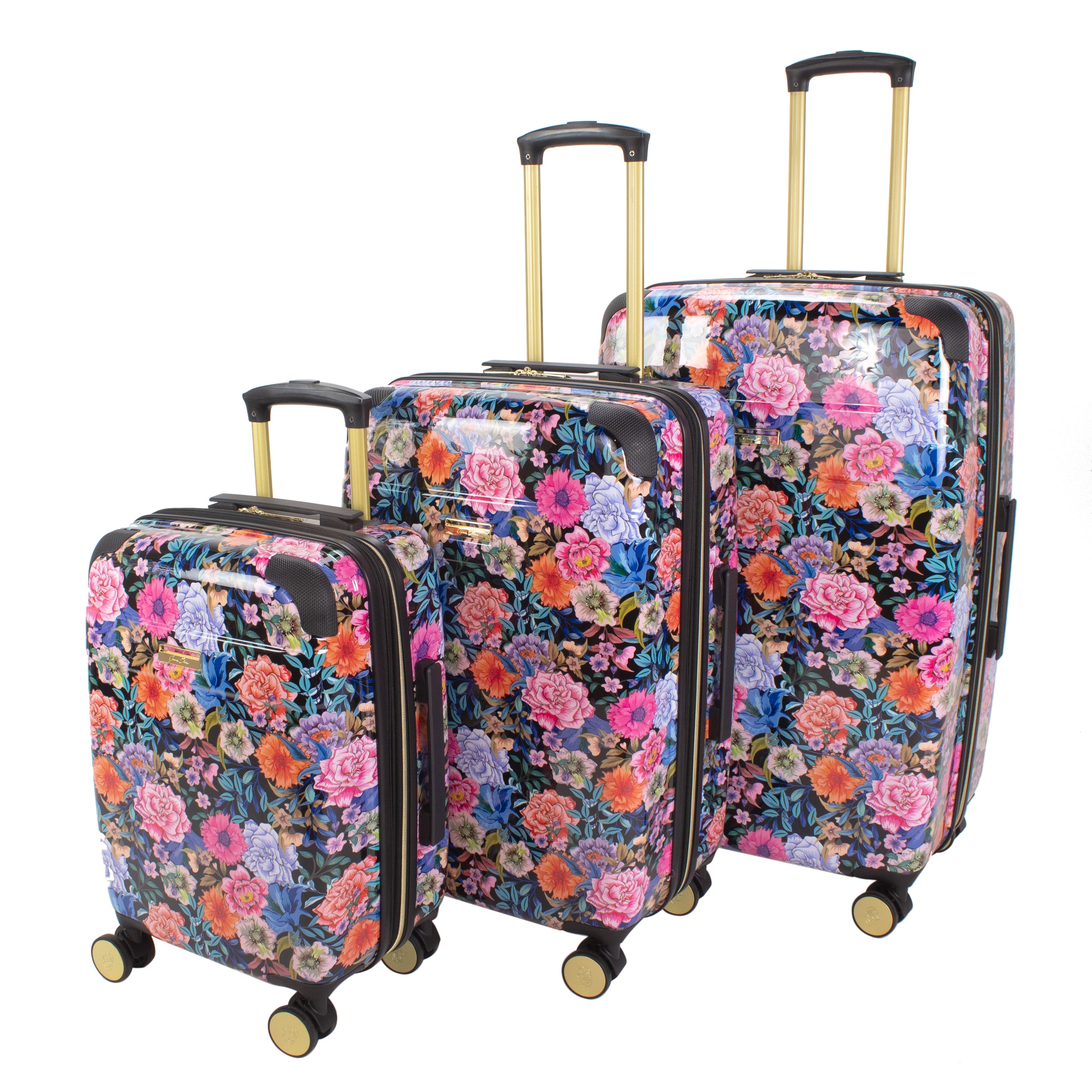 Set of three floral-patterned suitcases on a white background