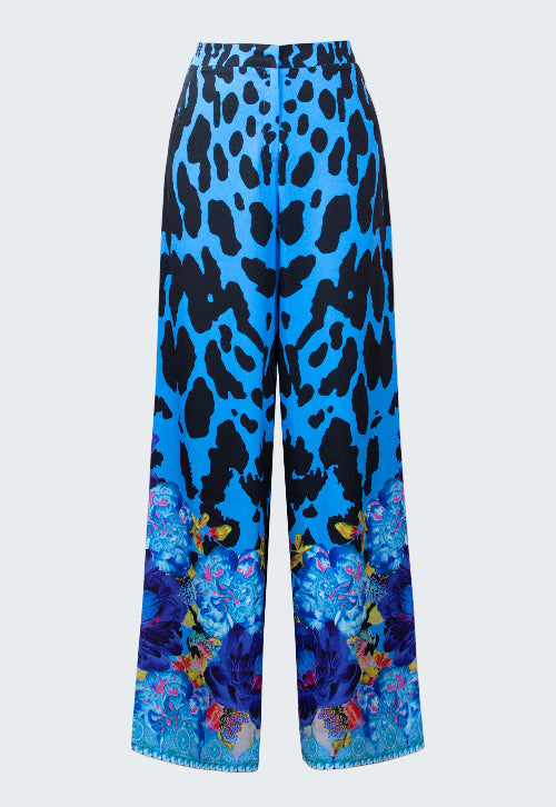 Blue pants with black leopard print and colorful butterfly design on a white background