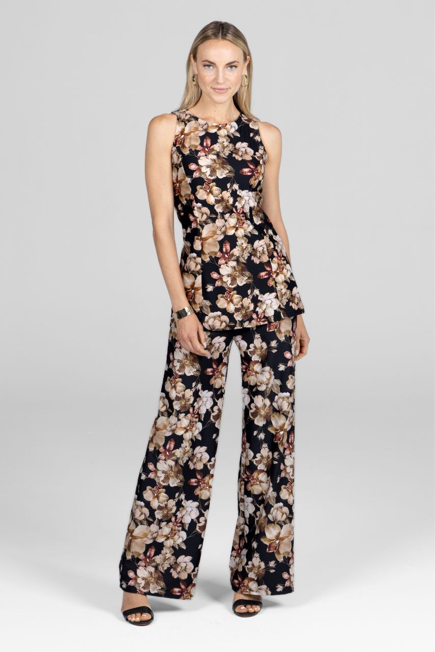 Woman wearing a floral jumpsuit on a white background