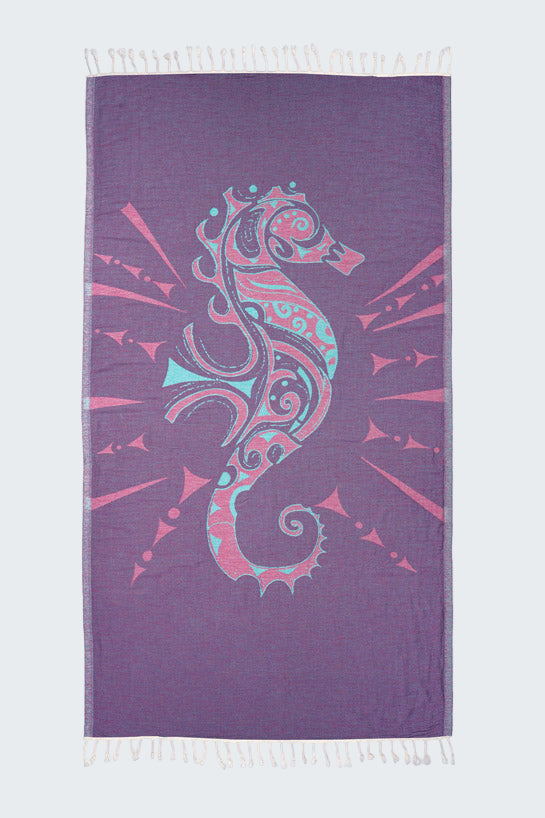 Purple towel with a colorful seahorse design on a white background