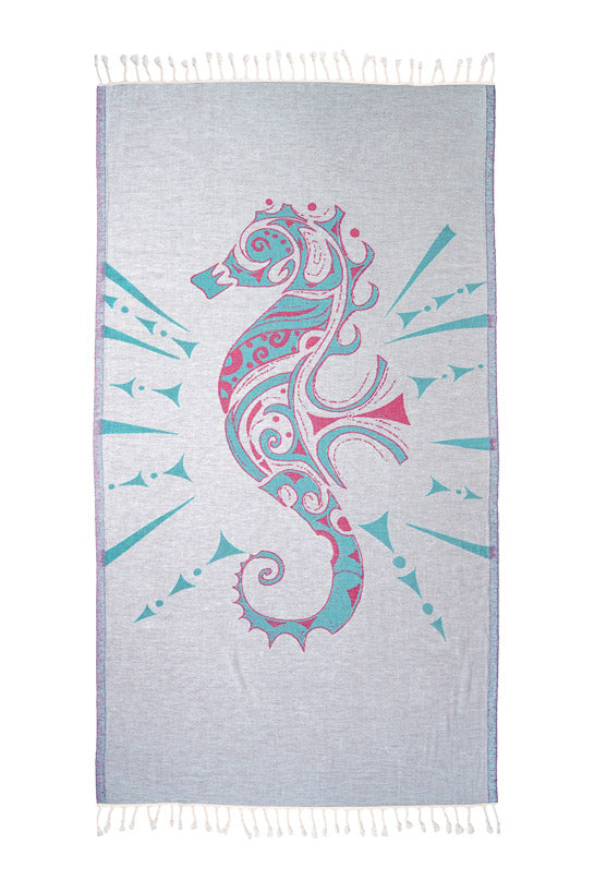 Towel with a pink and blue seahorse design on a light gray background