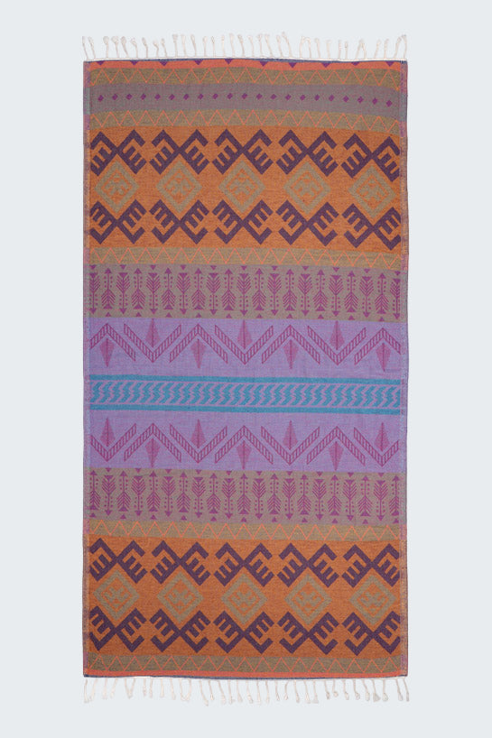 Multicolored patterned rug with geometric design on a white background