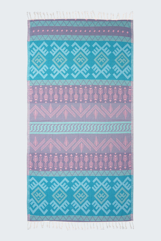Patterned towel with blue and pink geometric design on a white background