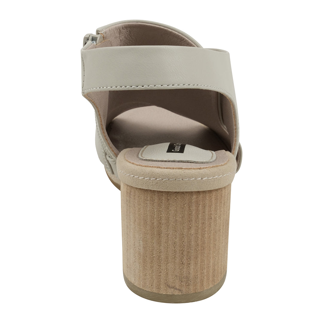 Beige sandal with a textured sole on a white background