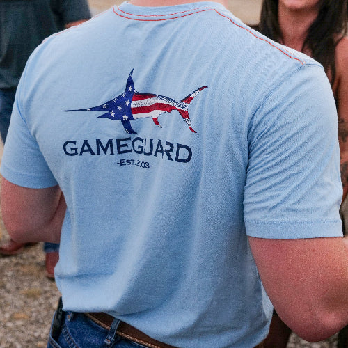 Light blue t-shirt with a fish design and 'GameGuard' text on the back