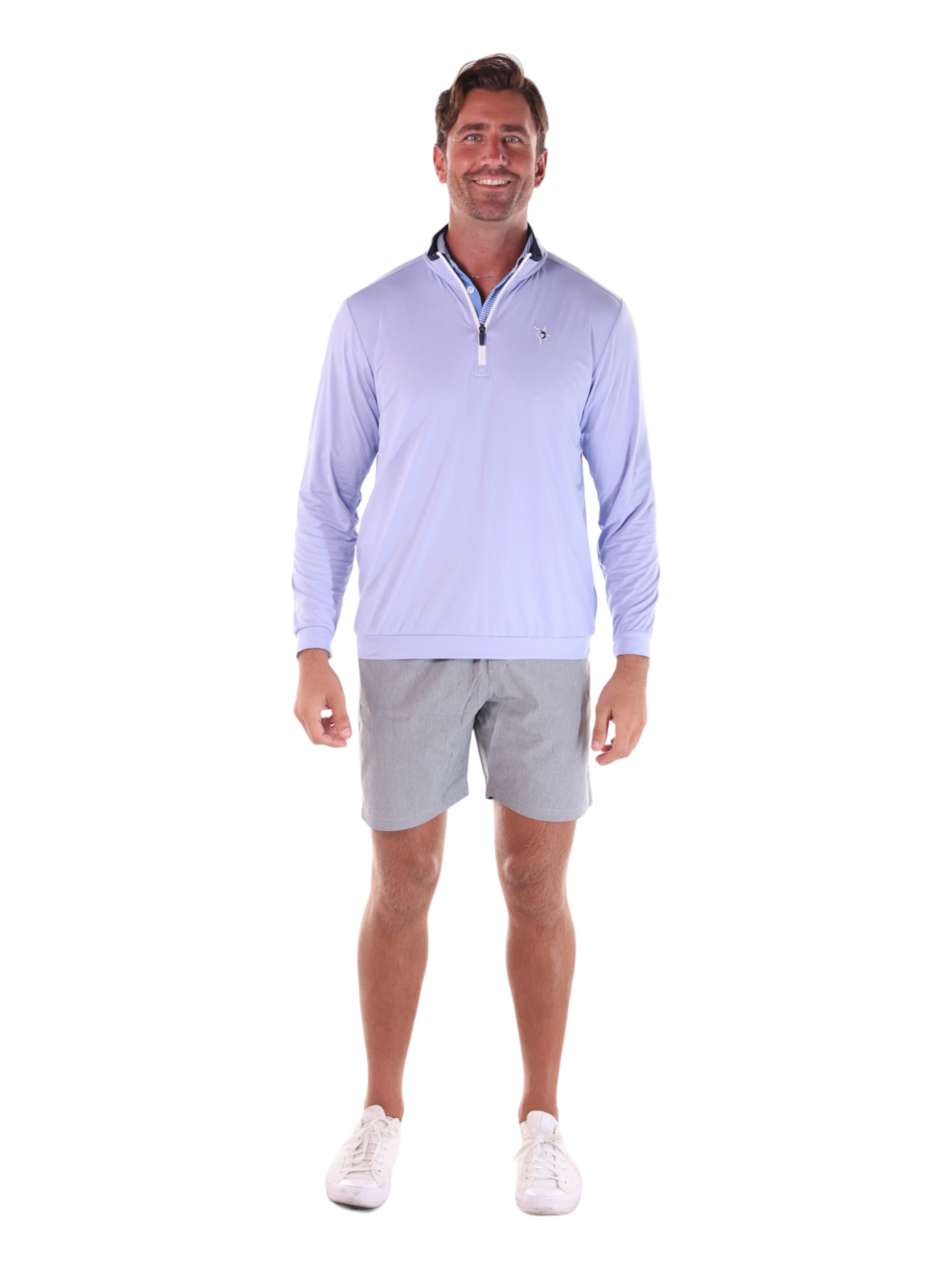 Man wearing a light purple long-sleeve shirt and gray shorts on a white background