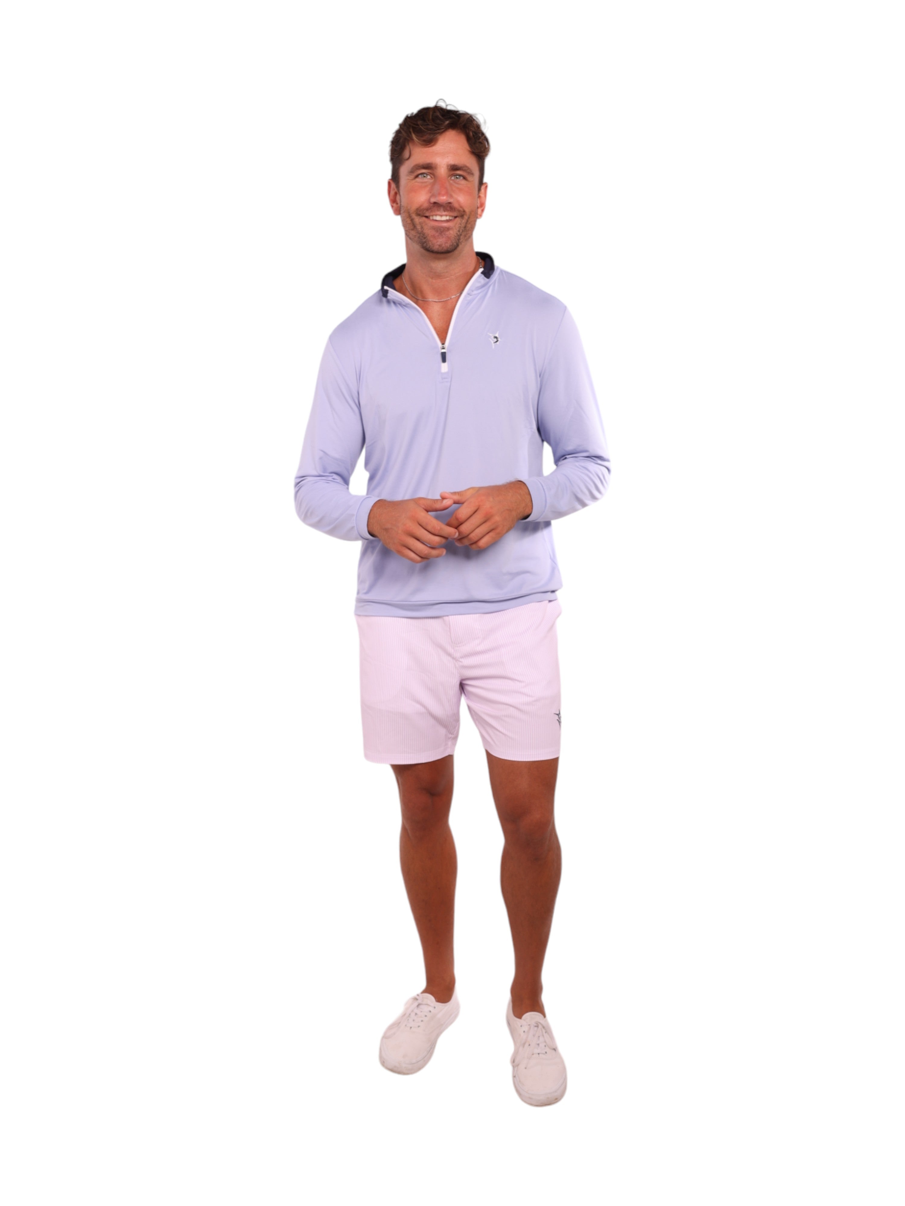 Man wearing a light purple long-sleeve shirt and white shorts on a white background