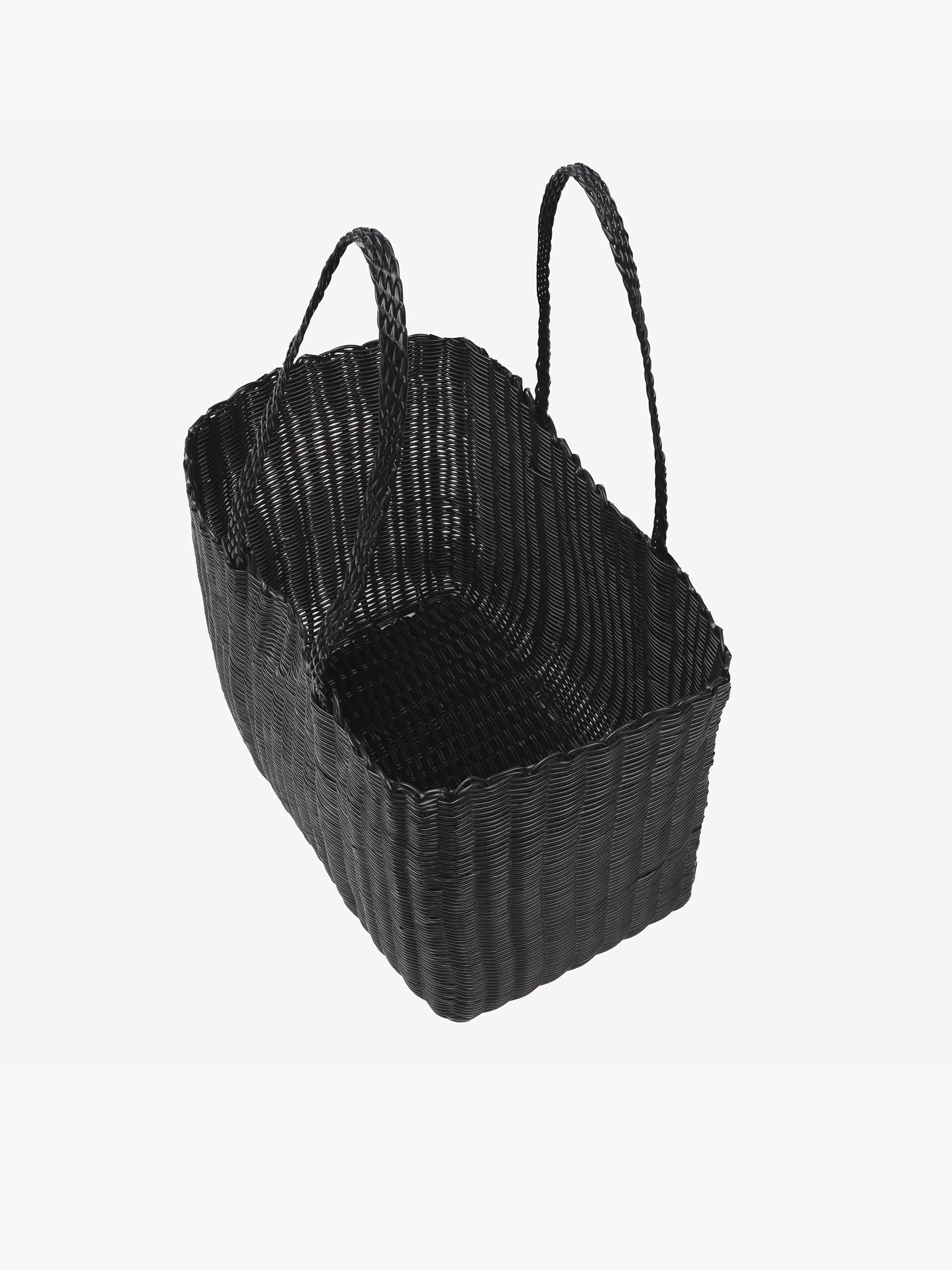 Black woven basket with handles on a white background
