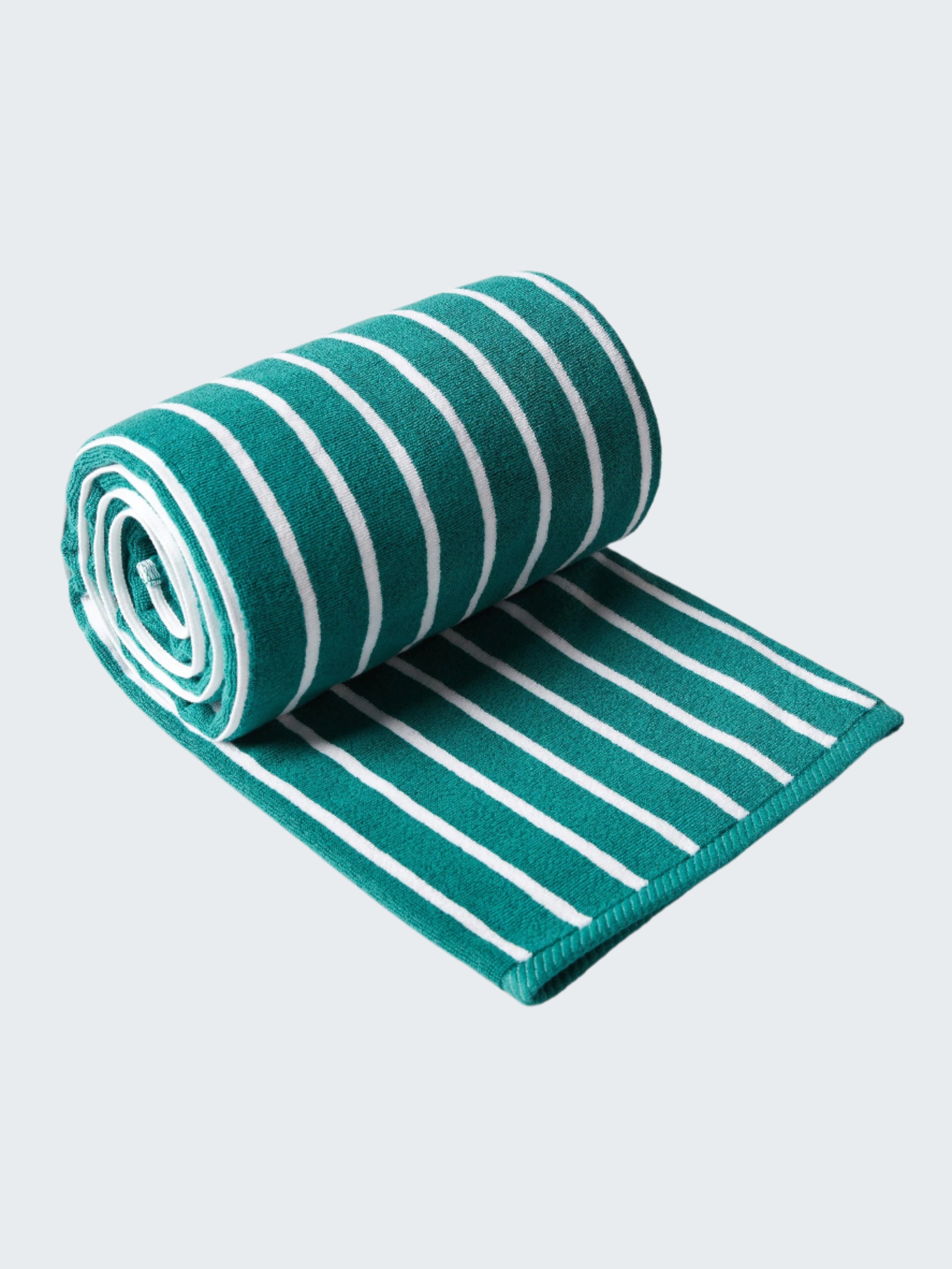 Roll of green and white striped fabric on a white background