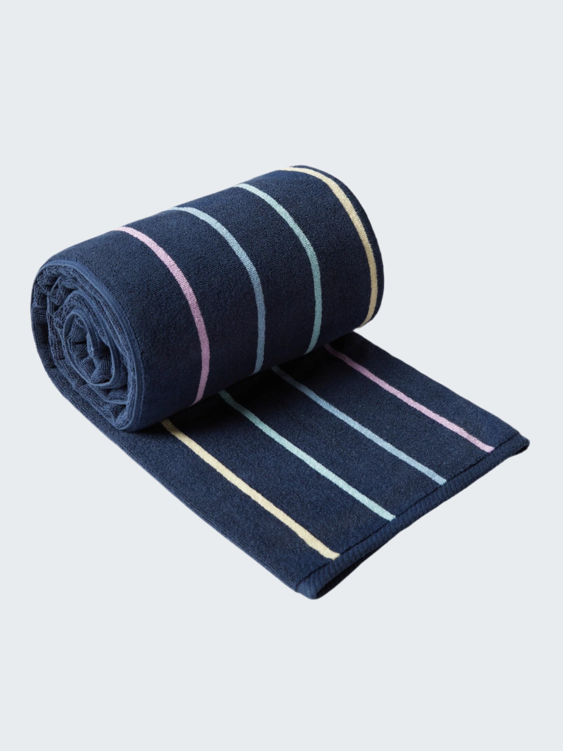 Rolled-up navy blue towel with colorful stripes on a white background