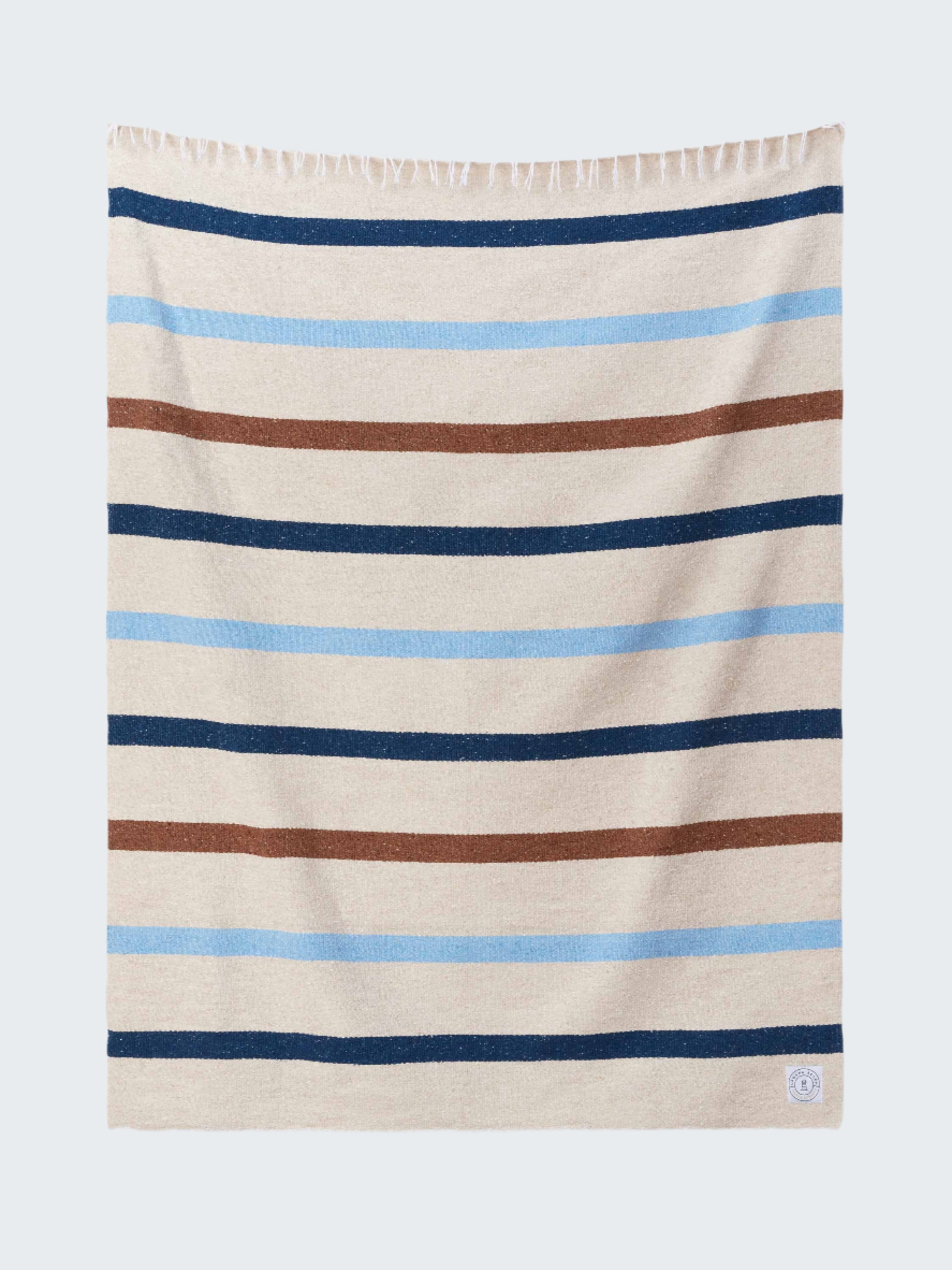Striped towel with blue, brown, and beige stripes on a white background