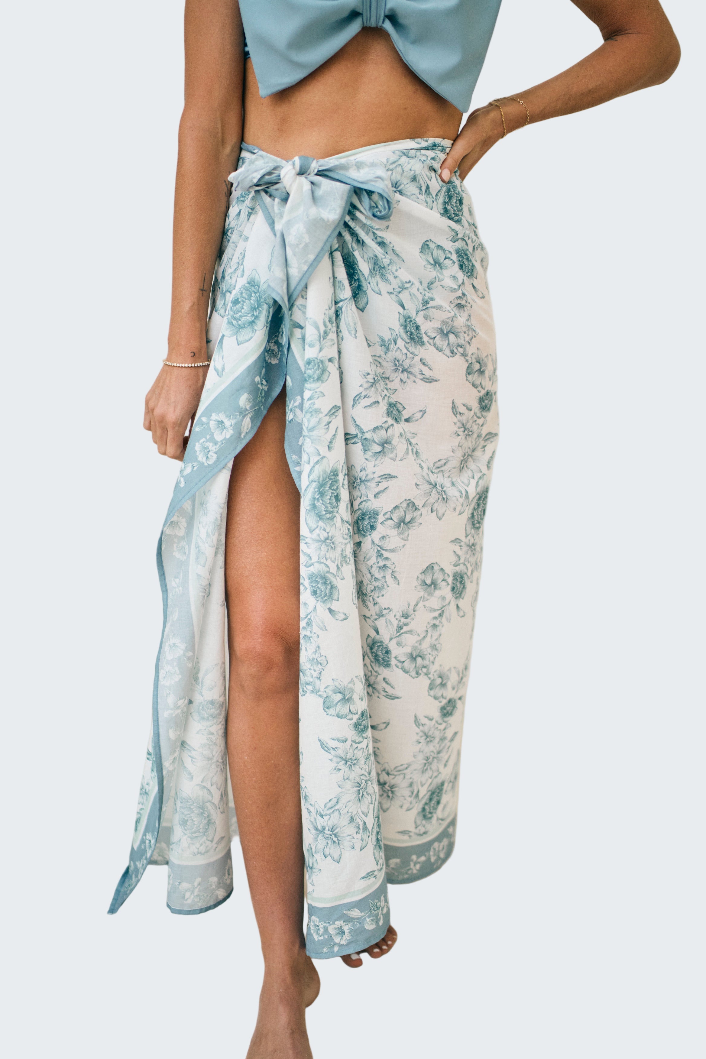 Person wearing a floral sarong with a white background