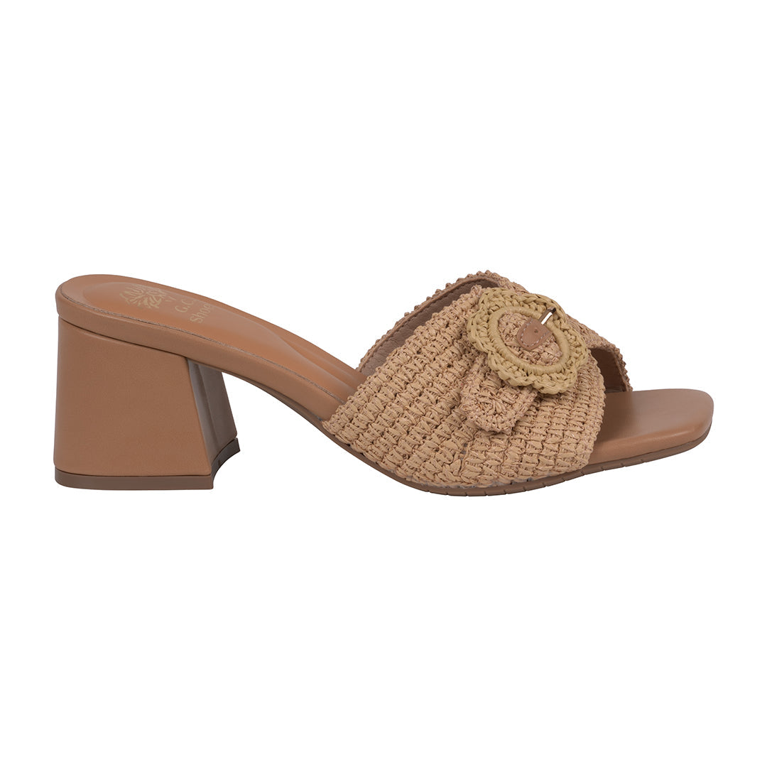 Beige sandal with a woven design and flower detail on a white background
