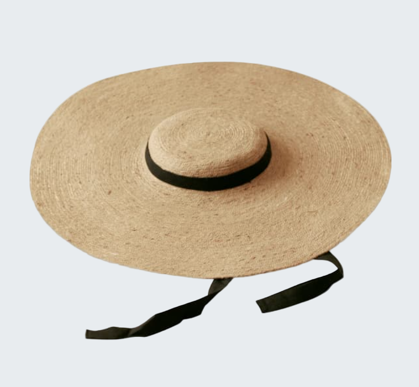 Beige straw hat with a black ribbon on a white background