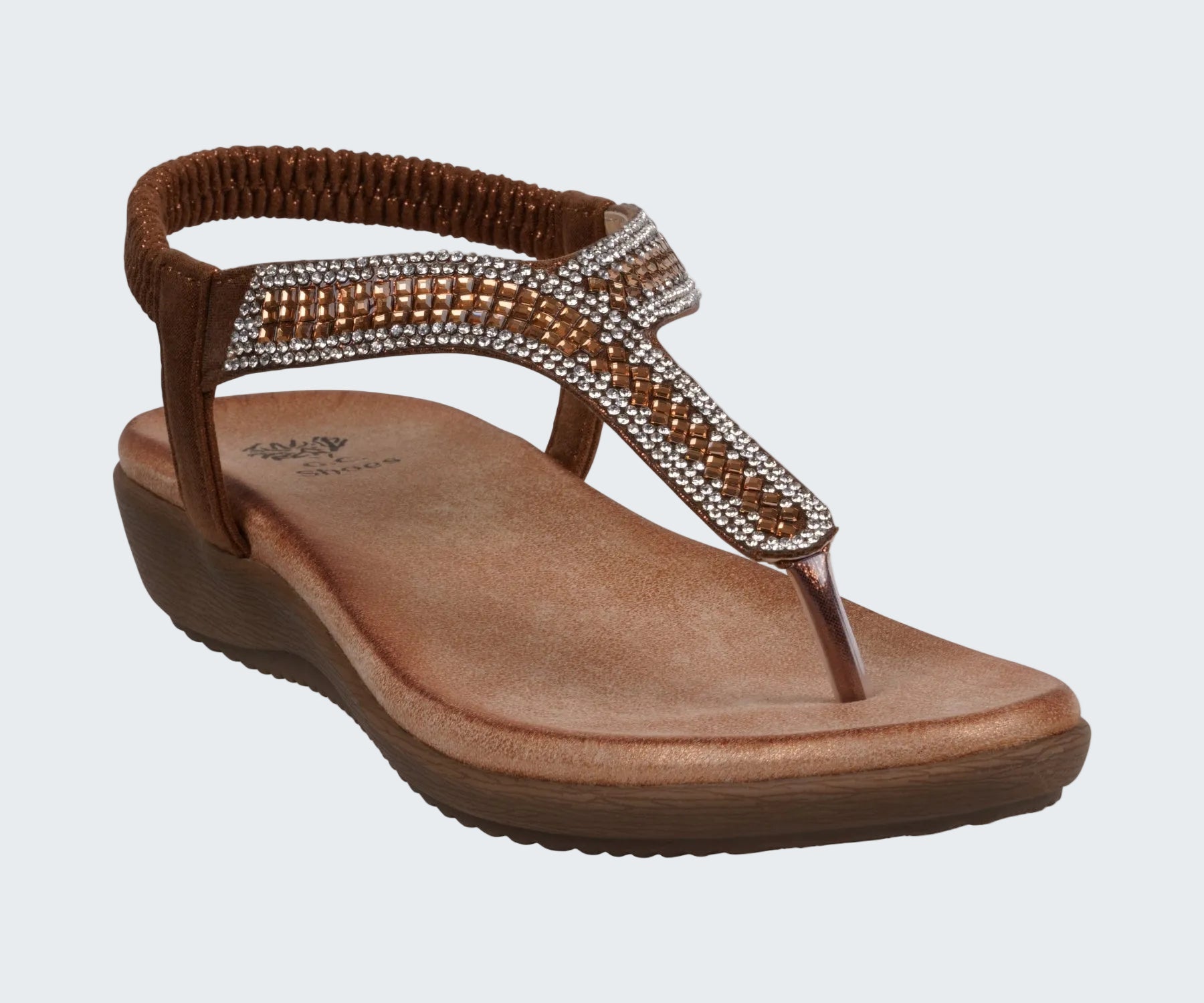 Brown sandal with rhinestone embellishments on a white background