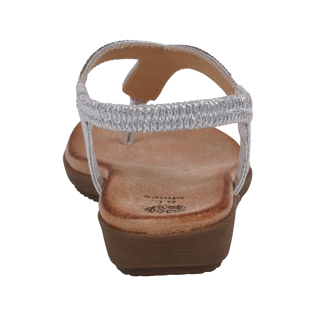 Brown sandal with a decorative silver strap on a white background